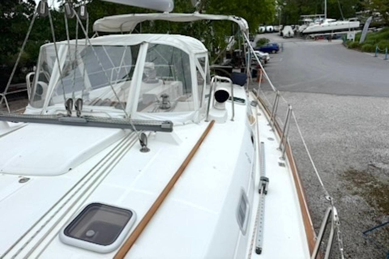 Beneteau 50 sailboat from 2001 docked in a marina, showcasing its deck and cockpit.