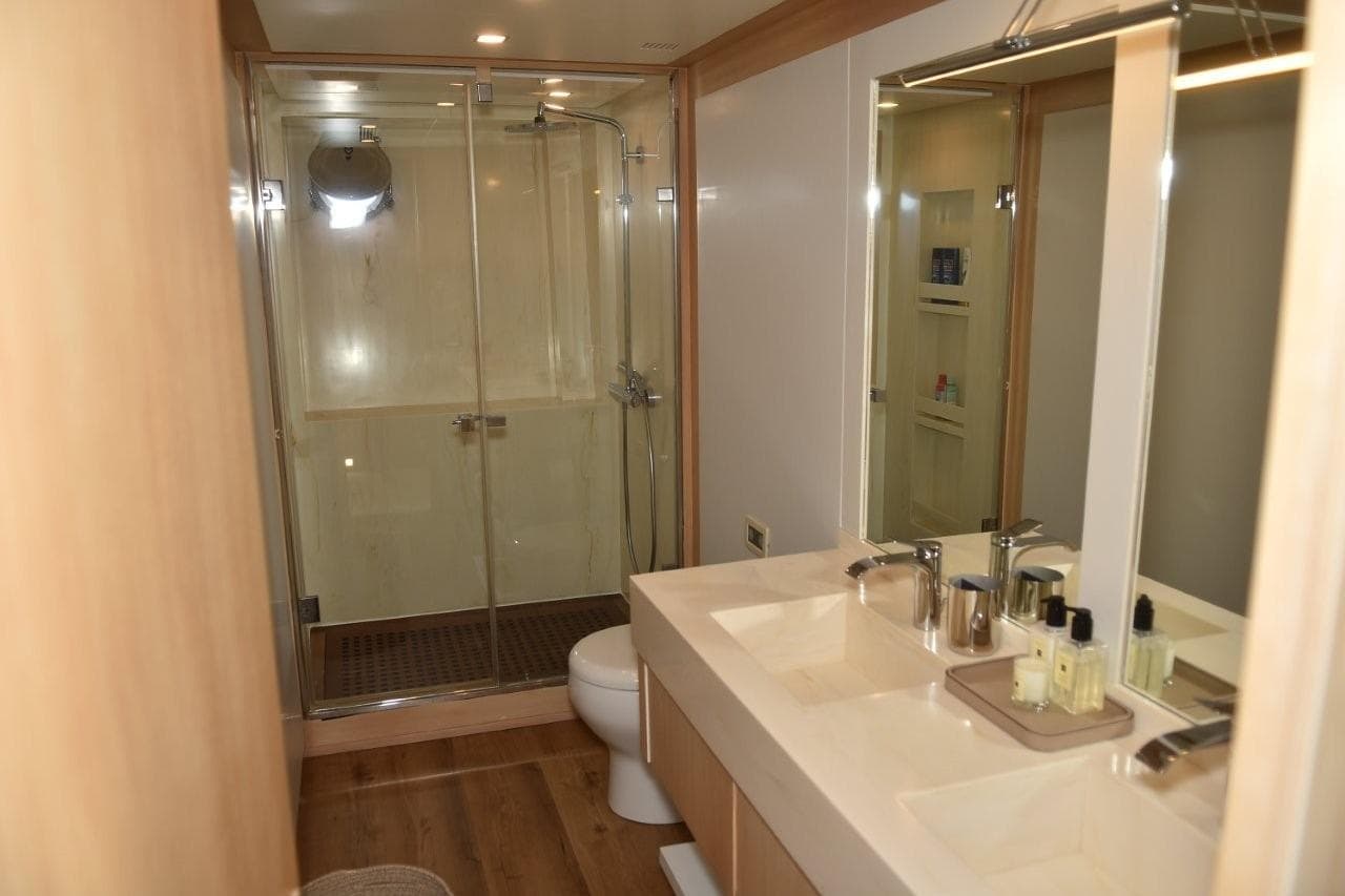 Luxurious bathroom in a 2007 Azimut 86S yacht with modern fixtures and spacious shower.