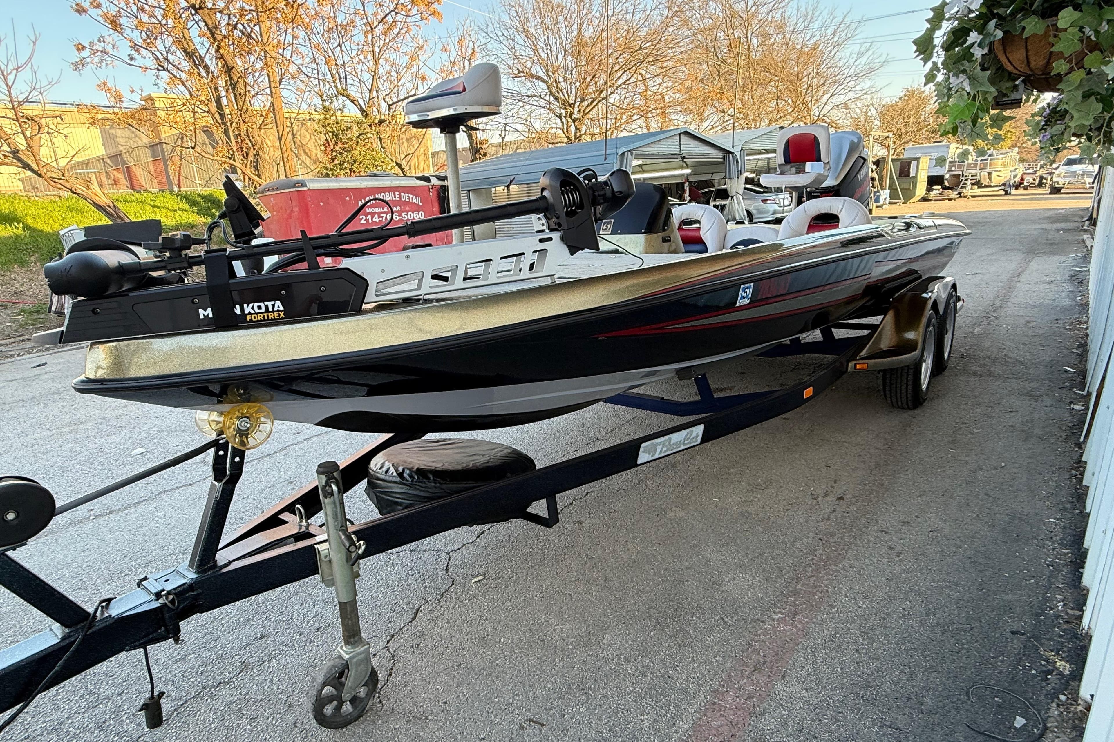 2005 Bass Cat Puma boat on trailer, featuring Minn Kota Fortrex motor.