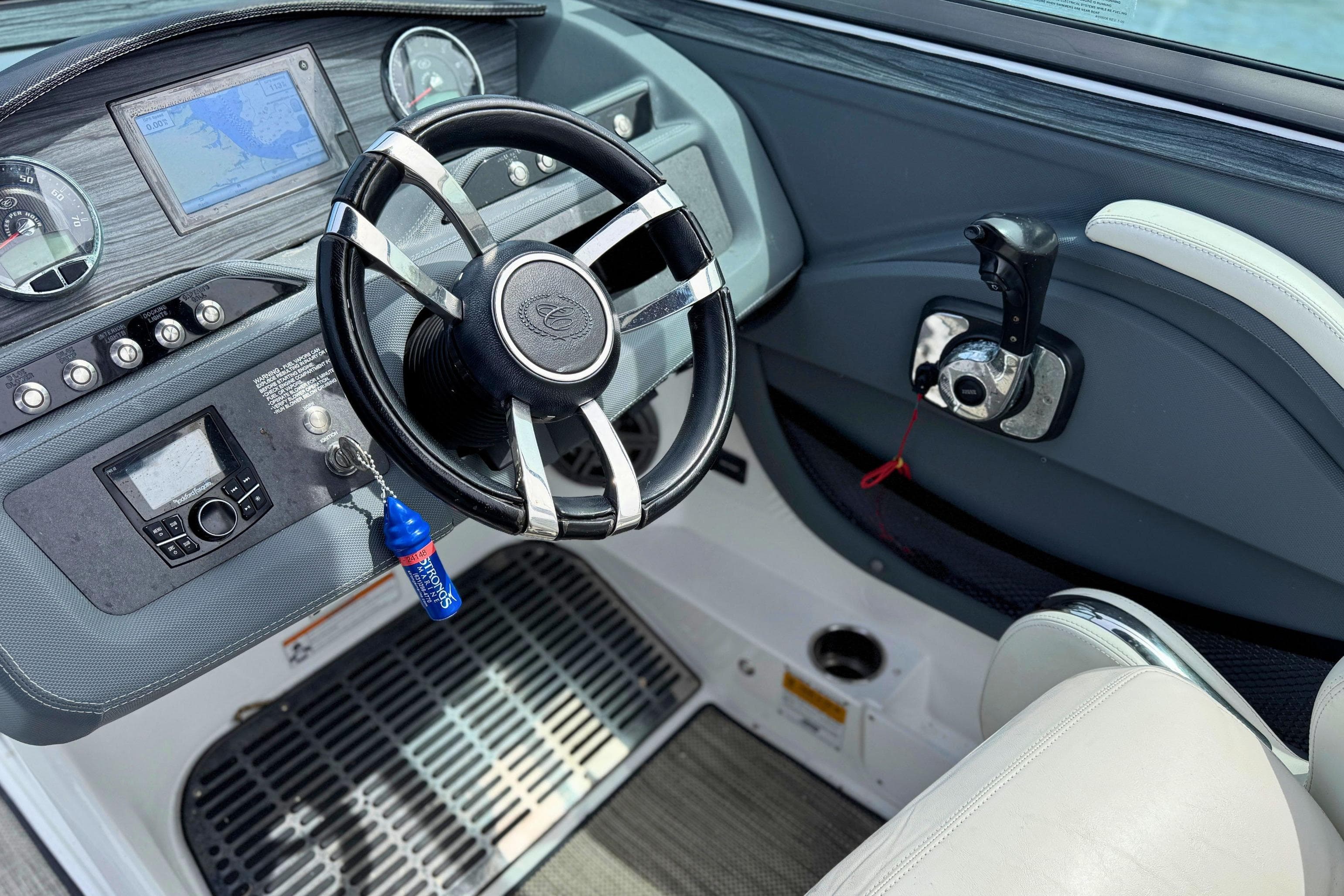 Interior view of 2016 Cobalt R5 boat dashboard with steering wheel and controls.
