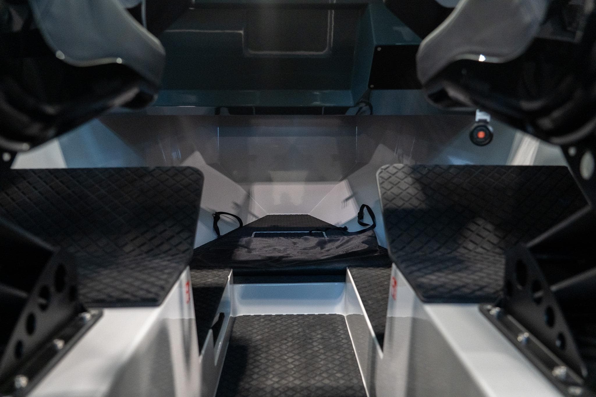 Interior view of 2024 Goldfish X10 EXPLORER boat, featuring sleek design and textured flooring.