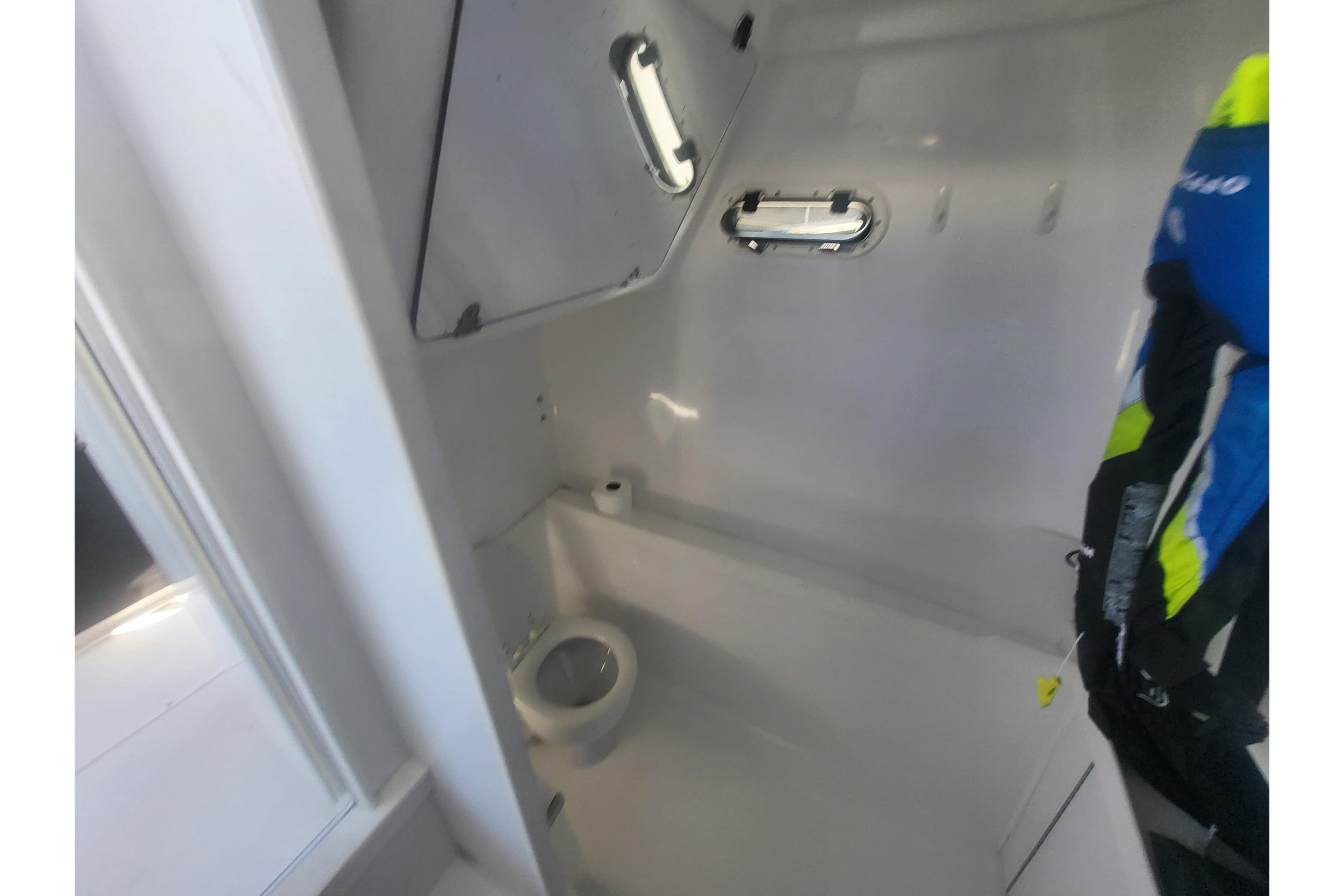2005 Stamas 310 Tarpon boat interior with compact marine toilet and storage.
