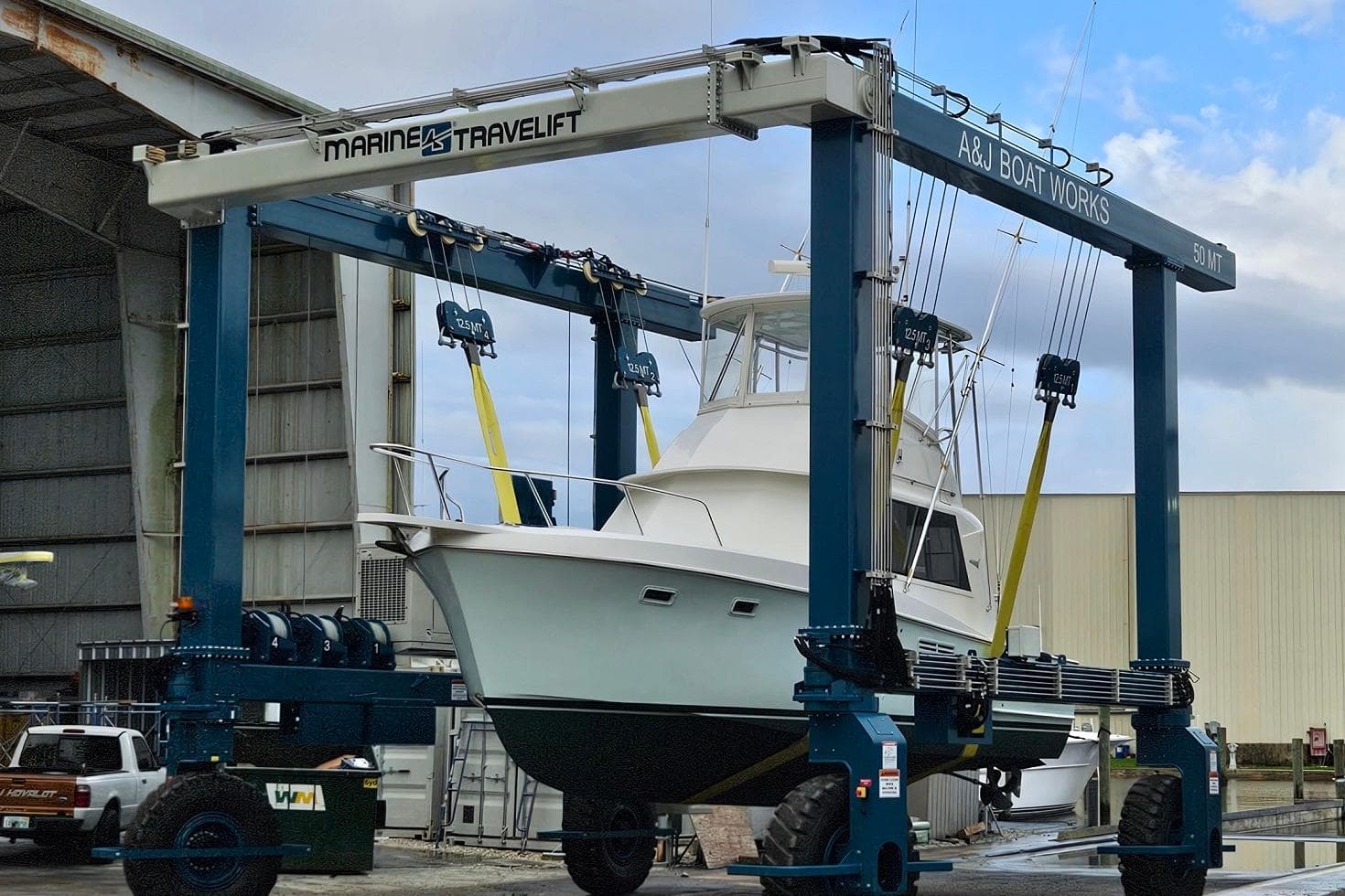1968 Hatteras 34 Sport Fisherman boat lifted by Marine Travelift at A&J Boat Works.