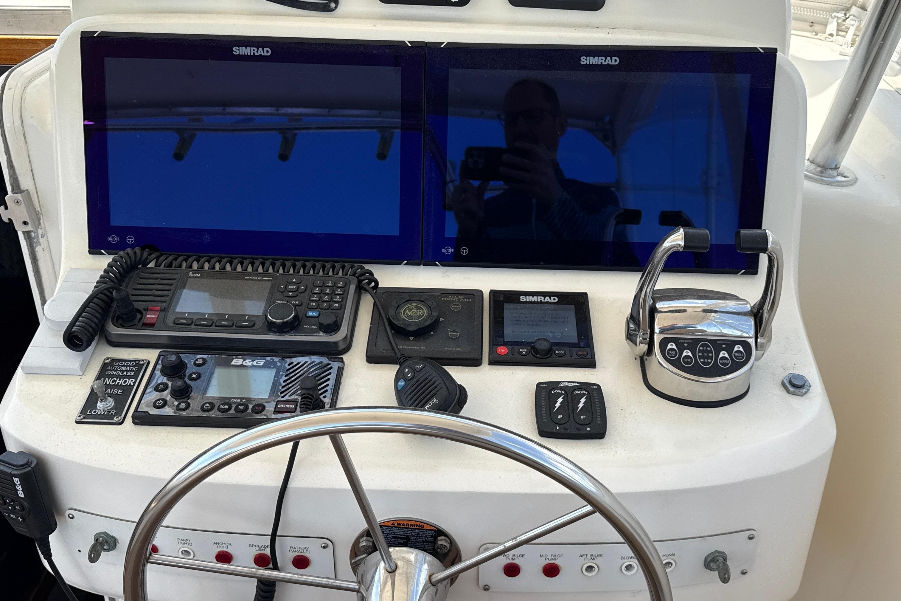 Helm of 2000 Dawson Yachts Express with dual Simrad displays and navigation controls.