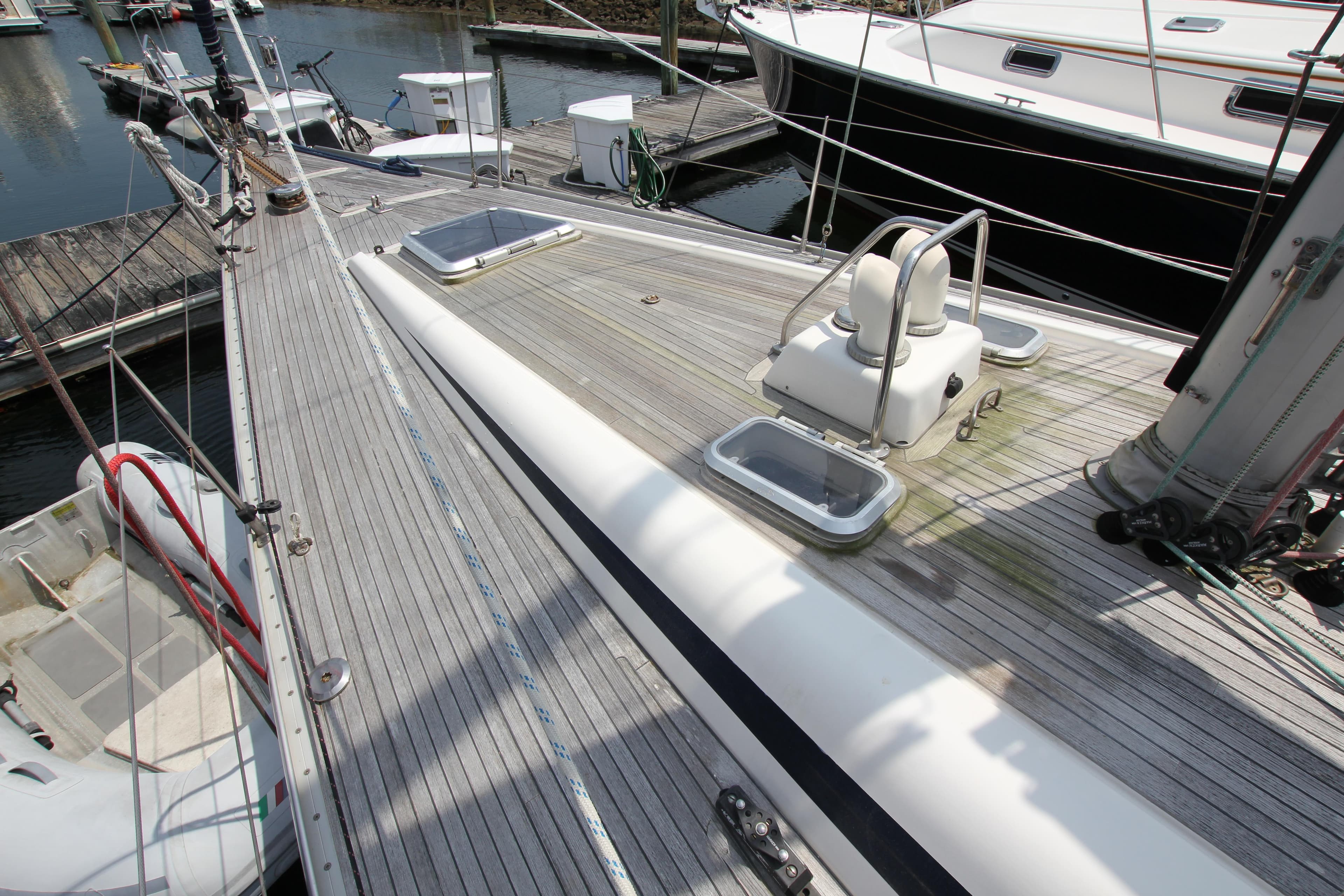 Deck of 1997 Nautor Swan 48 yacht, featuring sleek design and moored at a marina.
