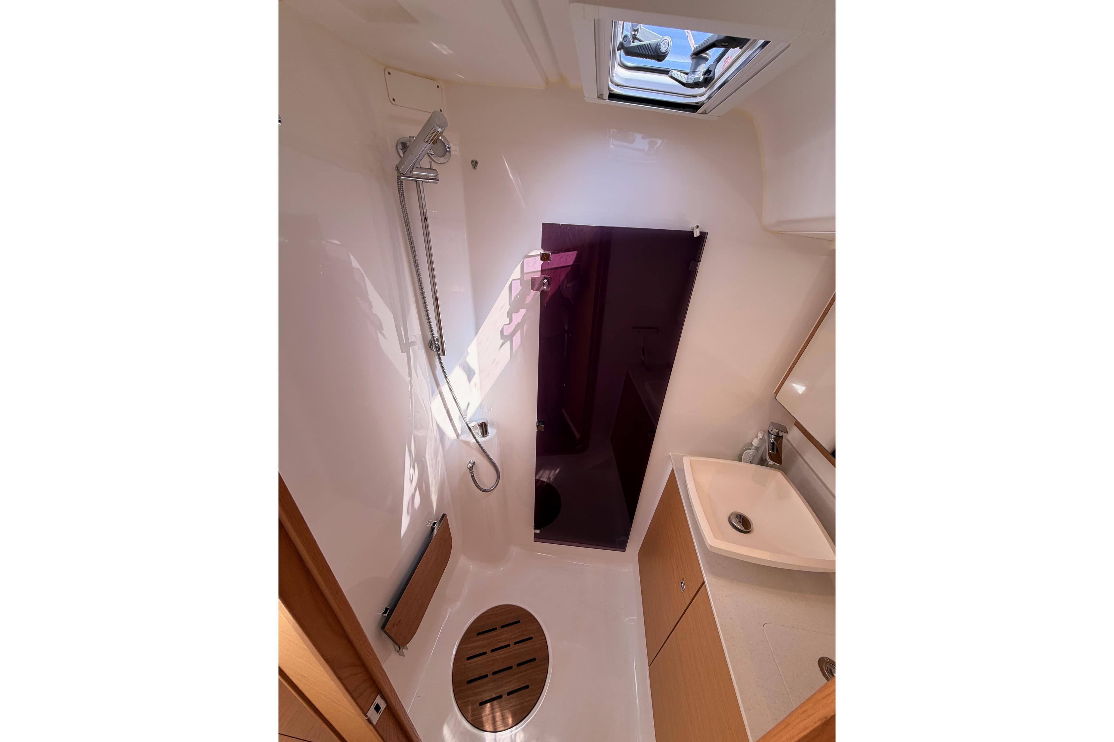 Modern bathroom in 2019 Dufour 460 Grand Large yacht, featuring shower and sink.