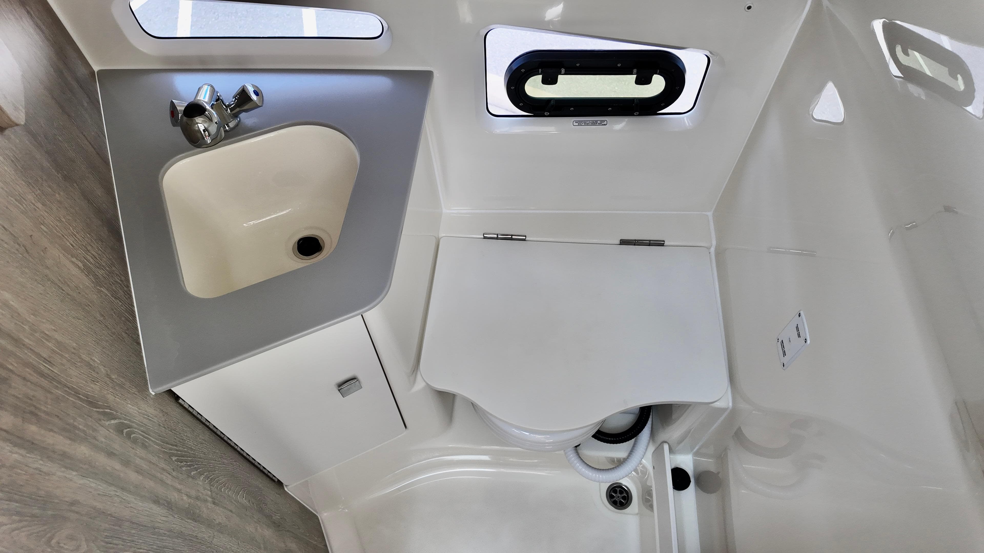 2025 Bayliner Trophy 29 Explorer bathroom with sink and compact toilet.
