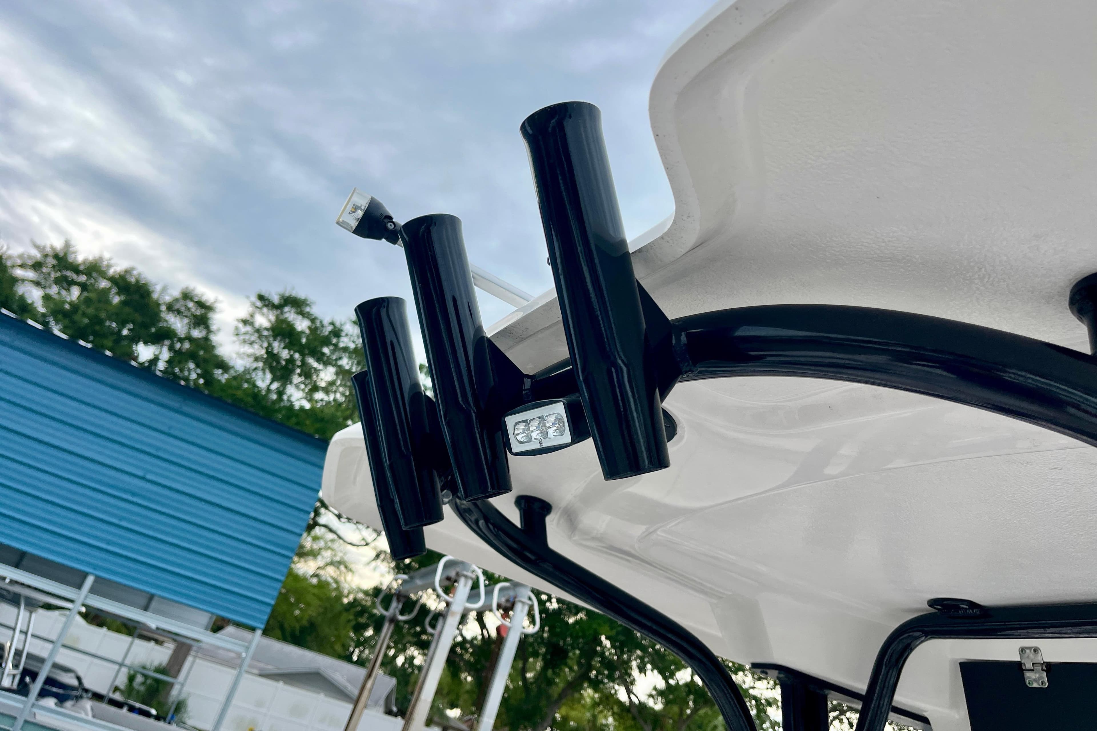2024 Robalo R230 Center Console boat with rod holders and canopy detail.