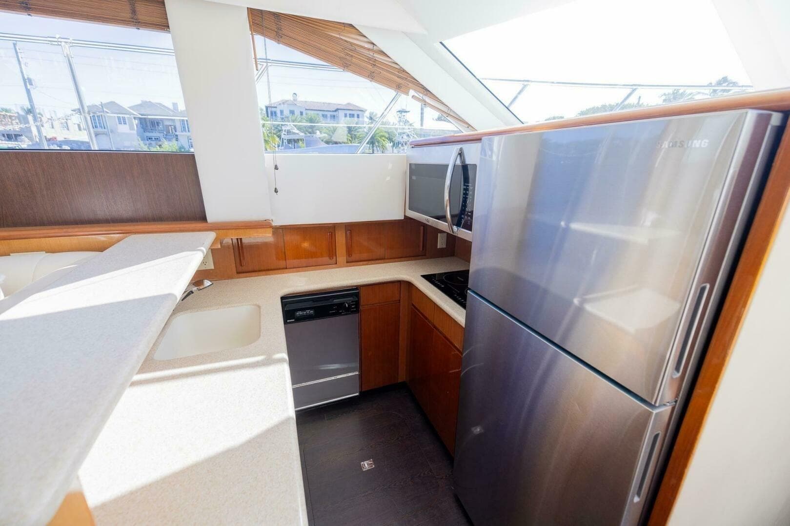 Modern kitchen in 1999 Hatteras 52 Sport Deck Motor Yacht with stainless steel appliances.