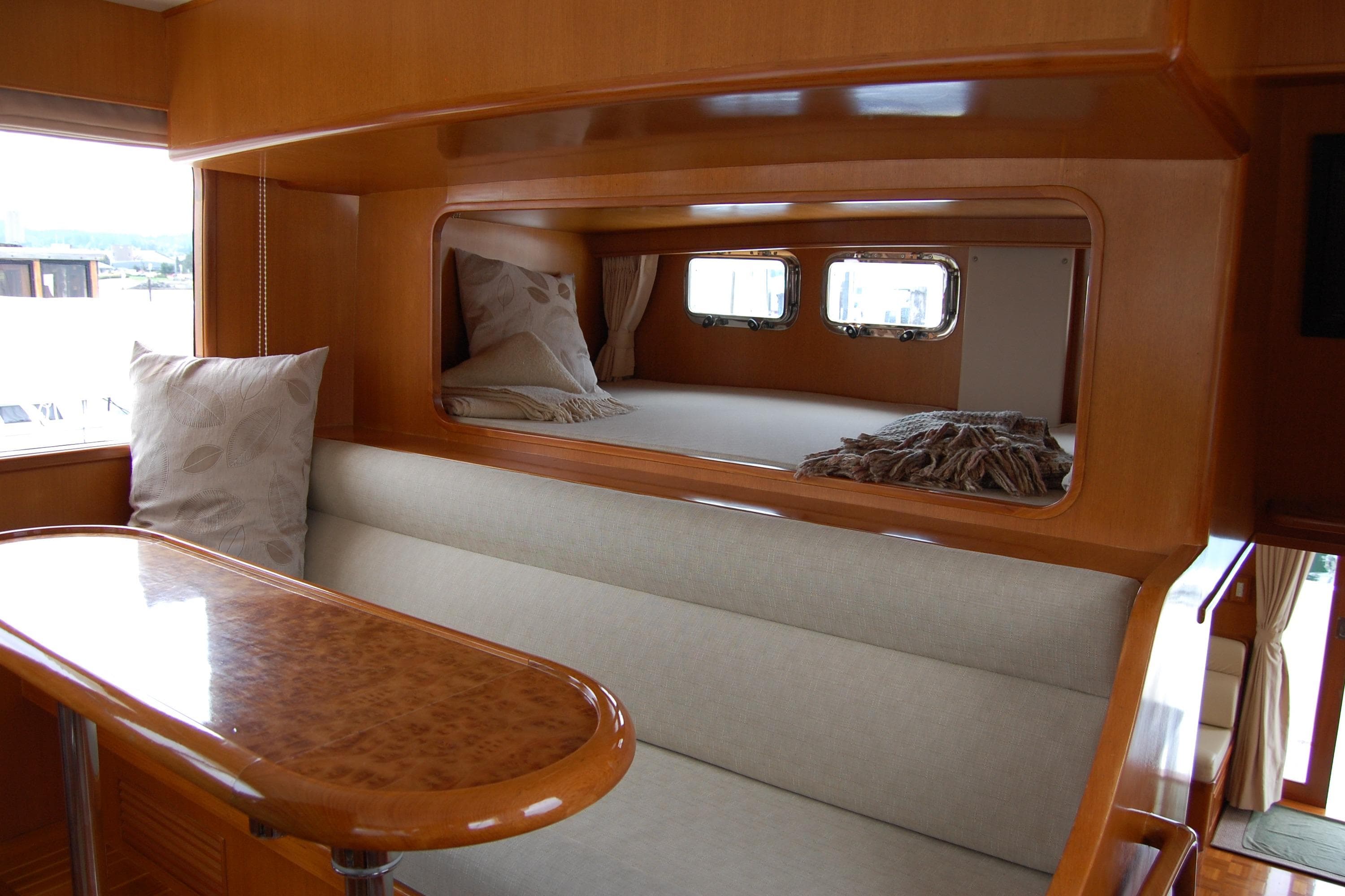 Luxurious interior of 2001 Ocean Alexander Classico yacht with elegant wood finish and cozy seating.