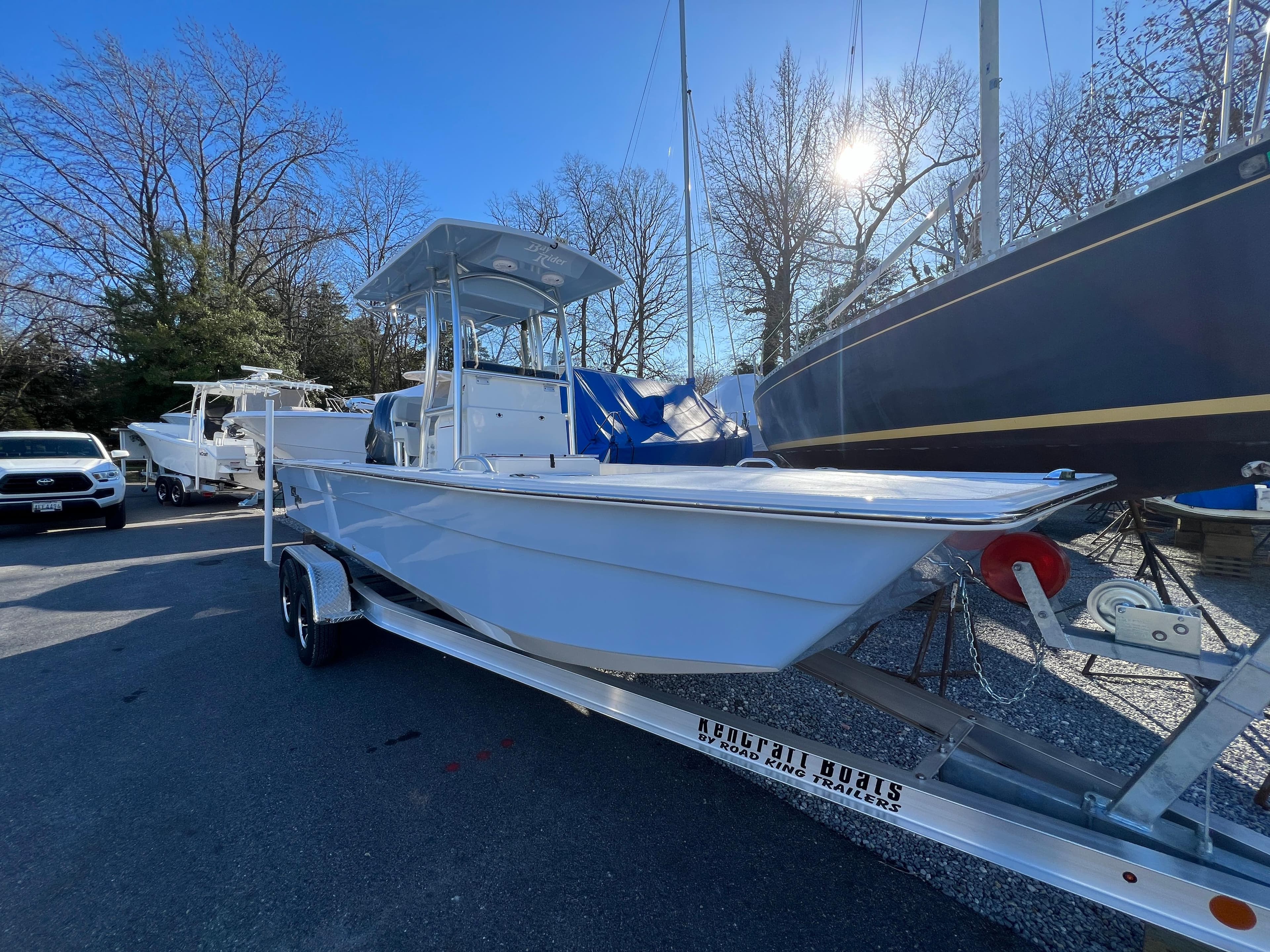 2025 KenCraft 2260FS Bay Rider Skiff on trailer in marina.