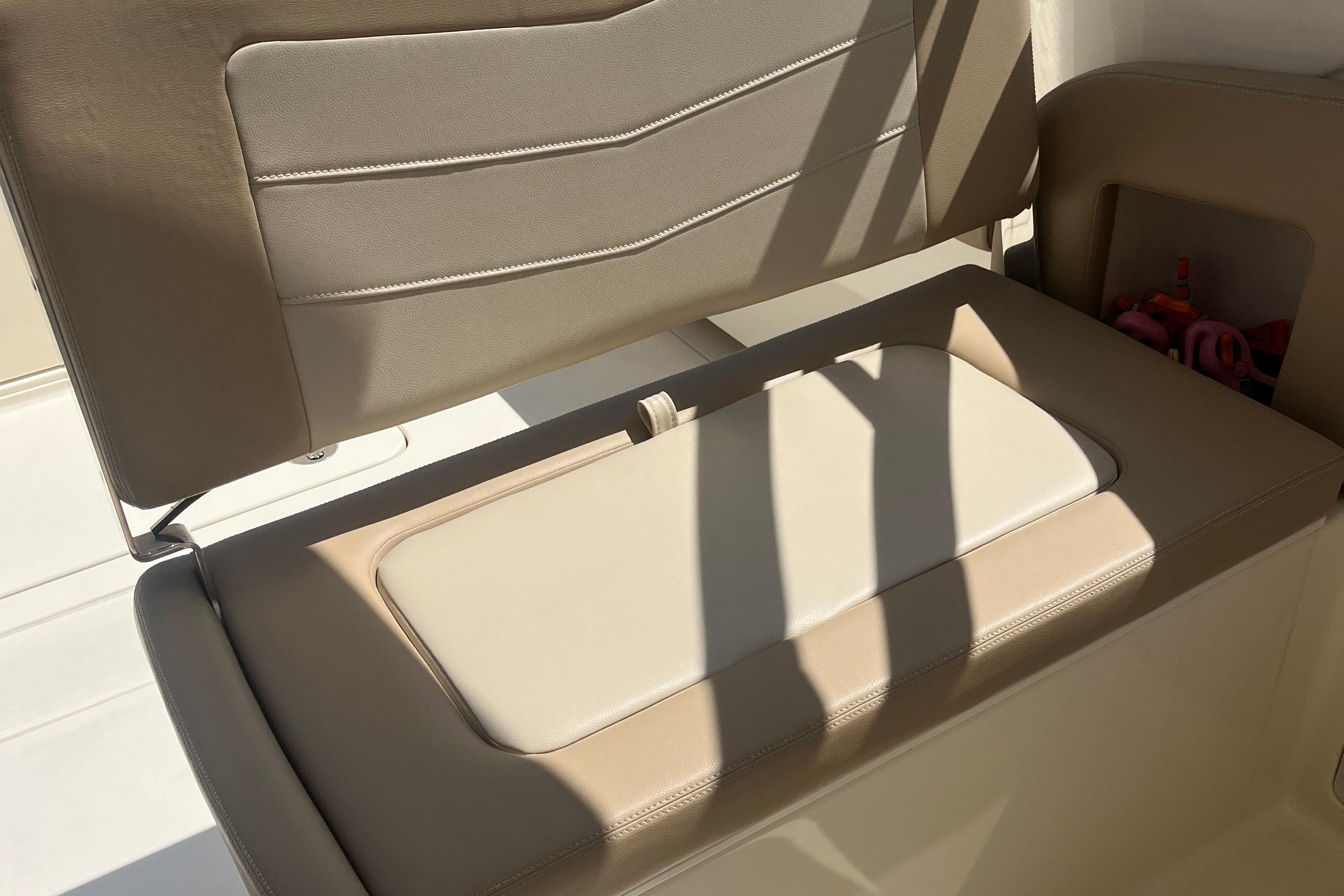 2024 Scout 240 Dorado boat seat with beige upholstery and storage compartment.