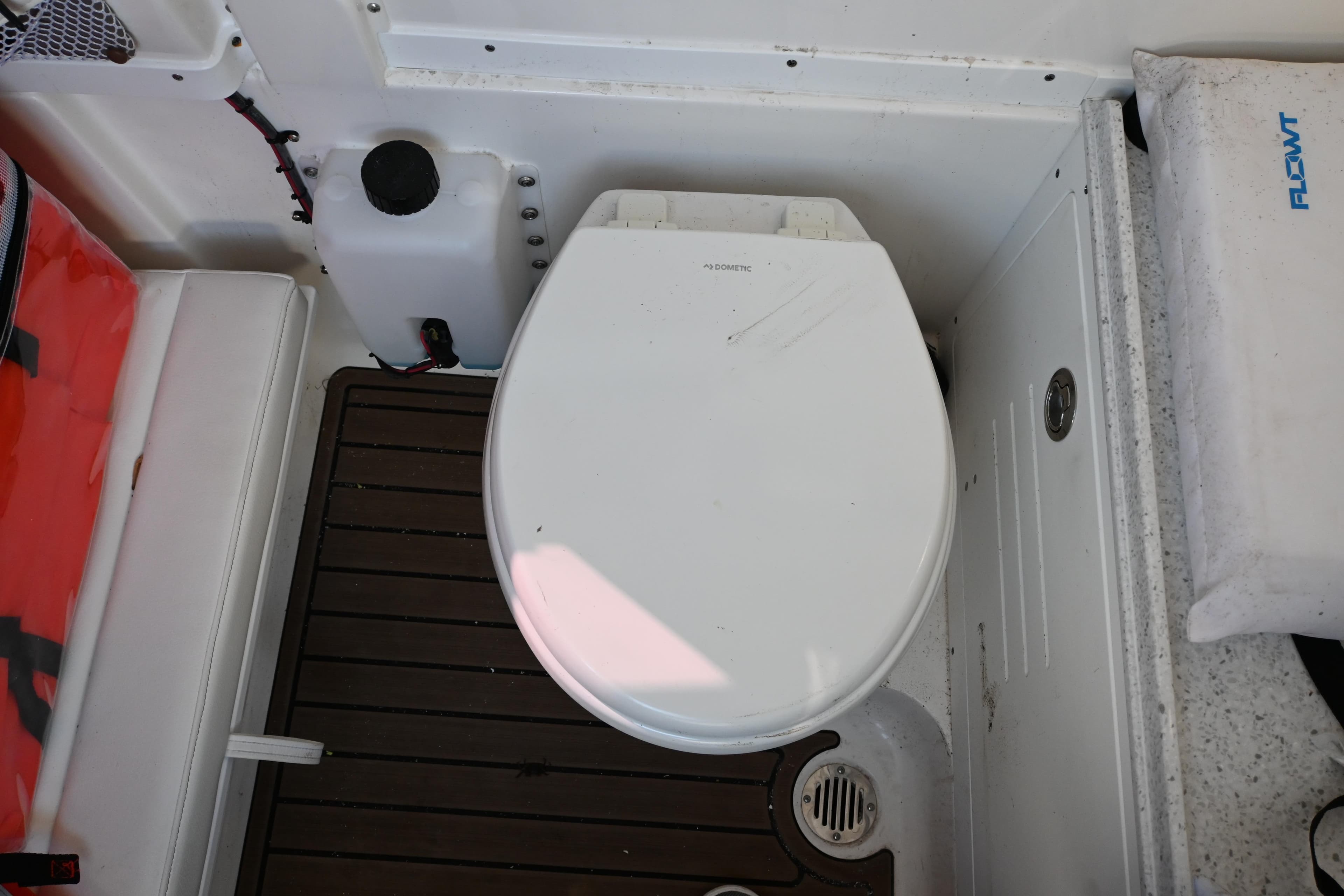 2025 Tidewater 320 CC Adventure boat toilet area with wooden flooring.