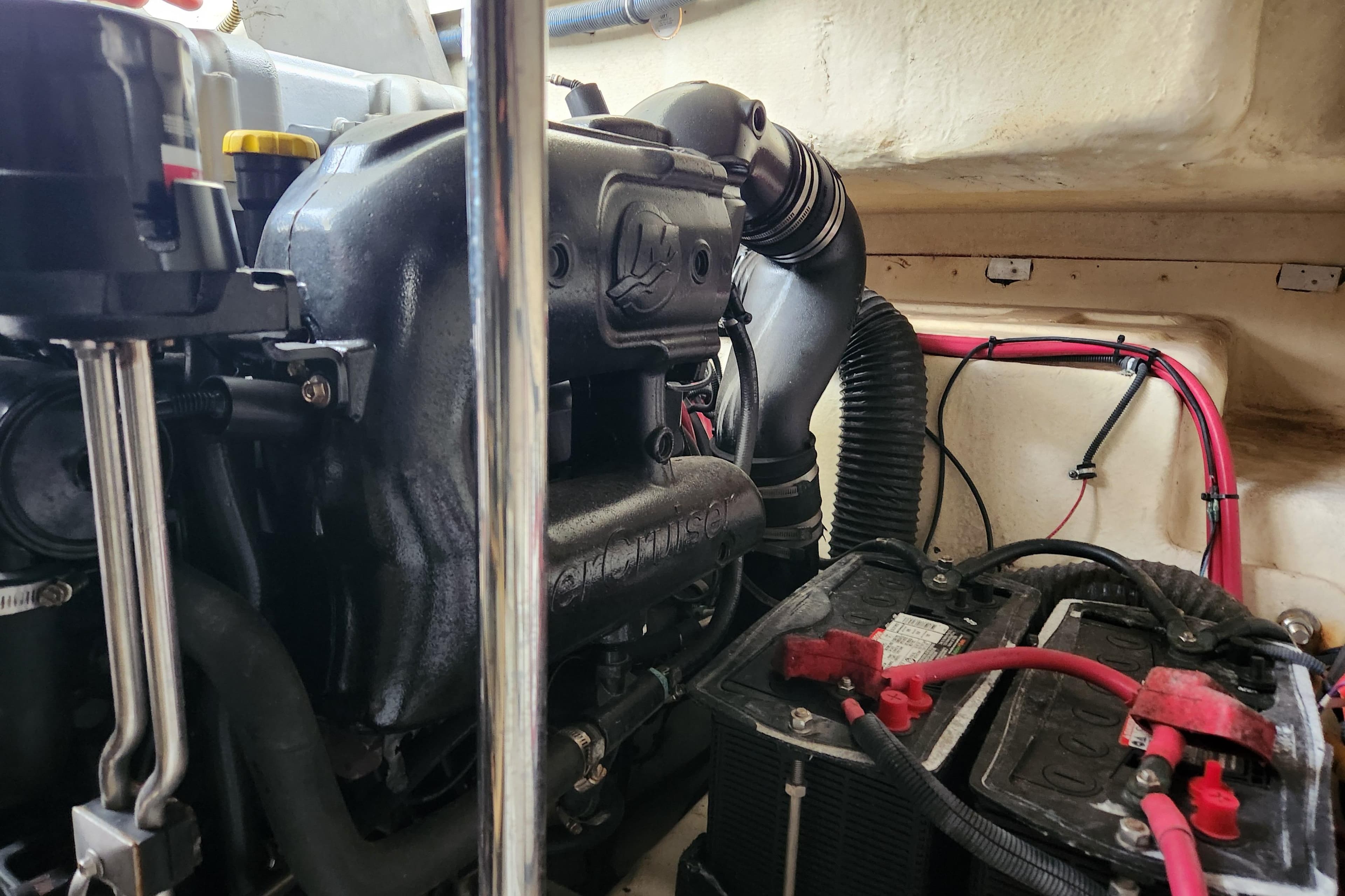 Engine compartment of a 2015 Formula 34 Performance Cruiser with visible battery and wiring.