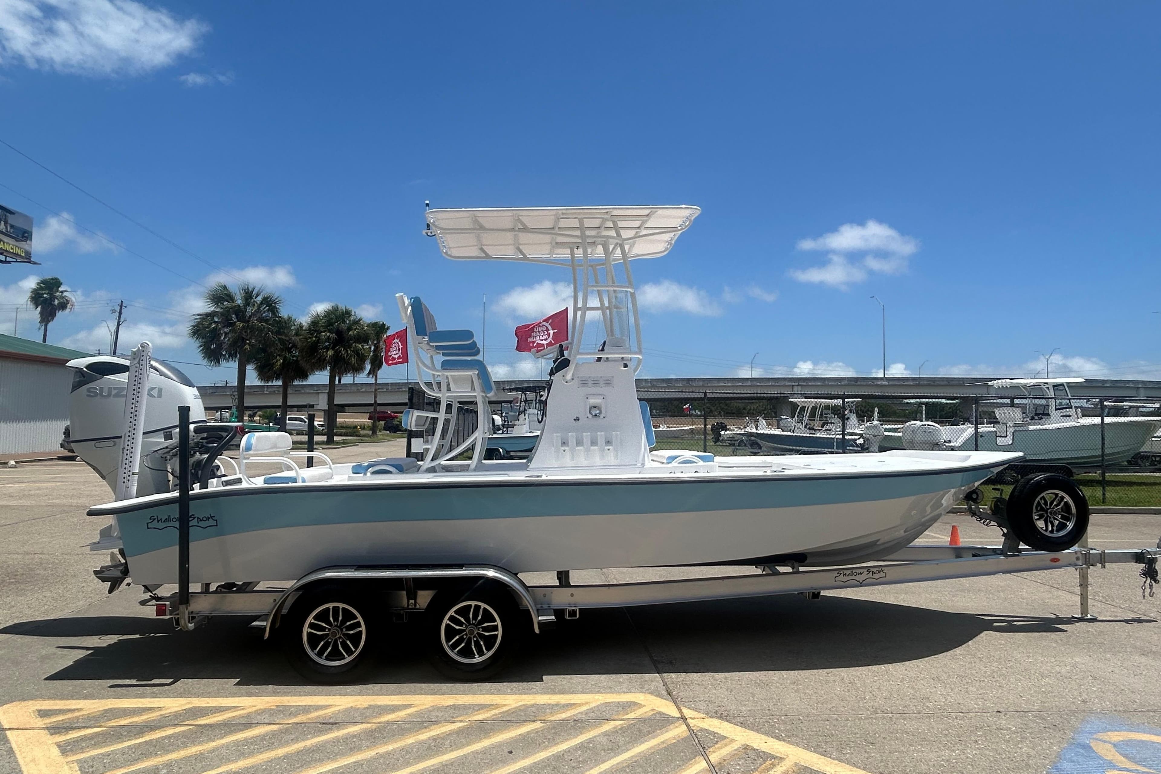 2026 Shallow Sport 24 Modified V boat on trailer under clear blue sky.
