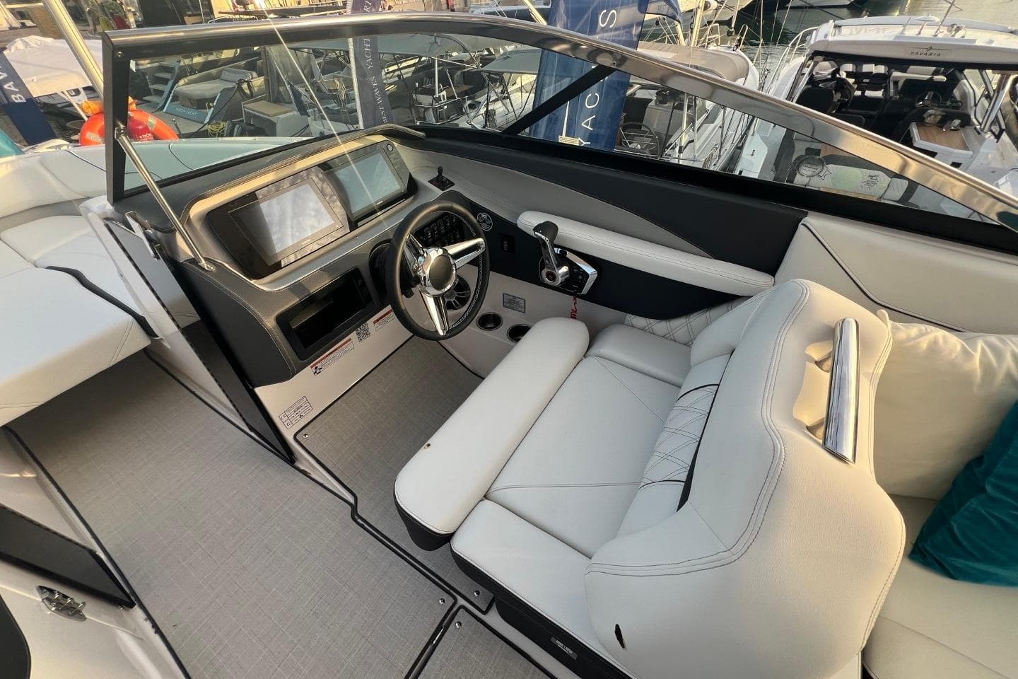 2025 Regal LS6 boat cockpit with modern steering, touchscreen display, and luxurious white seating.