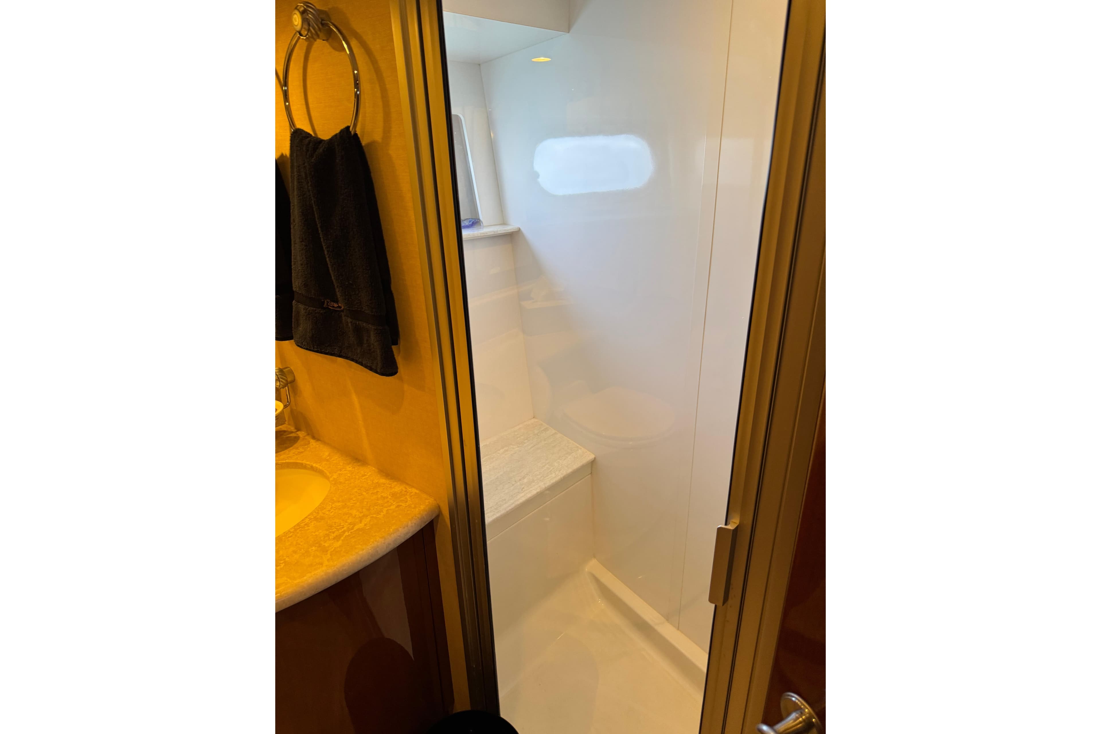 Shower area in 2006 Marquis 59 yacht bathroom with towel and sink.