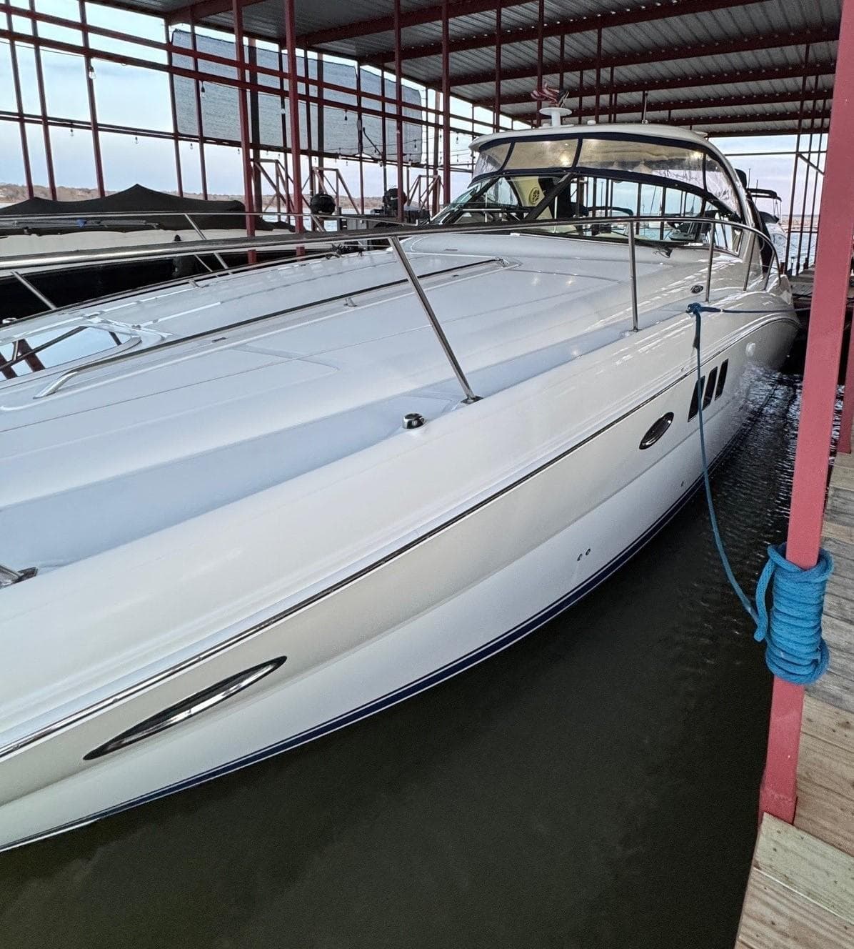 2007 Sea Ray 38 Sundancer yacht docked in a covered marina.