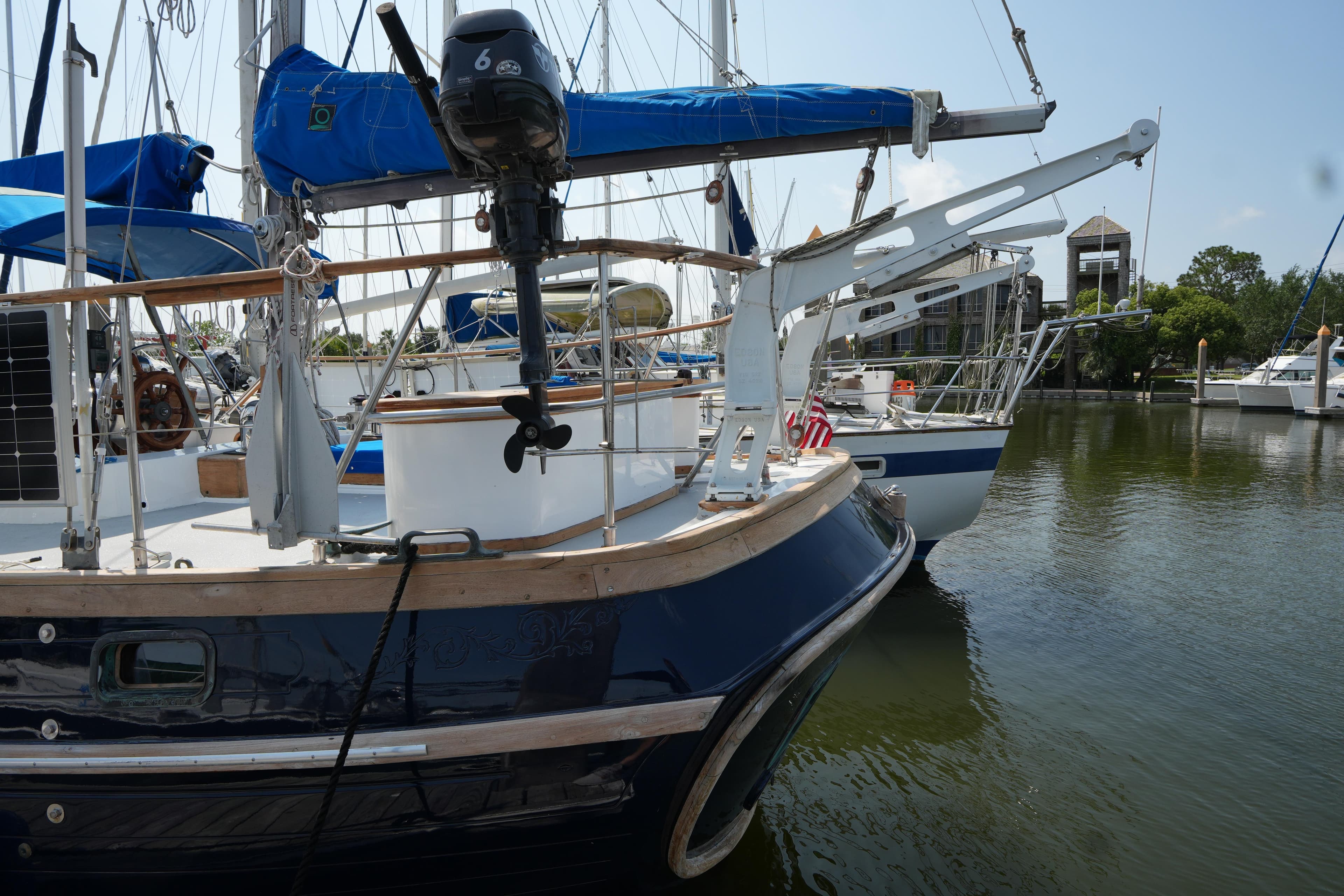 1982 Vagabond 47 sailboat docked in a marina, featuring blue and white design.