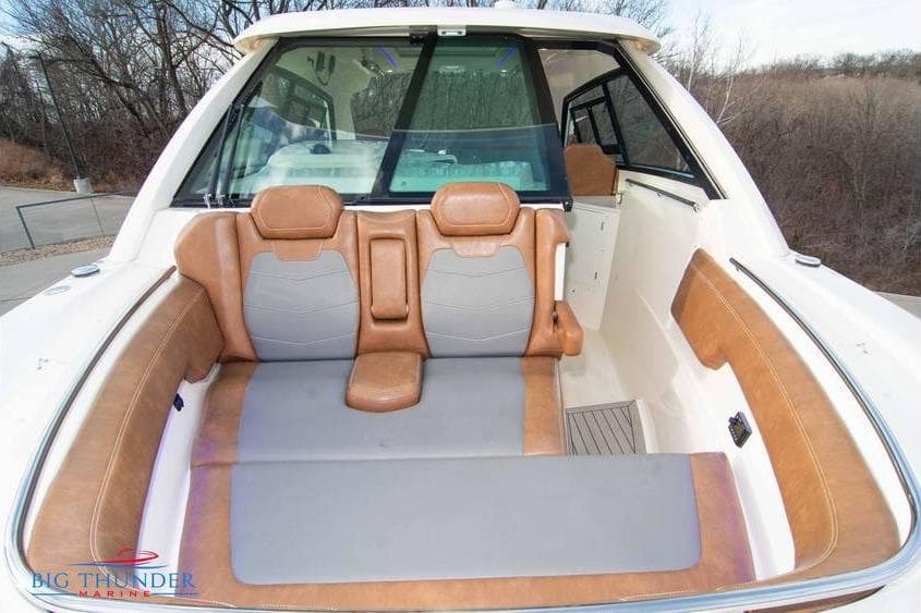 2022 Scout 350 LXZ boat interior with tan and gray seating, outdoor setting.