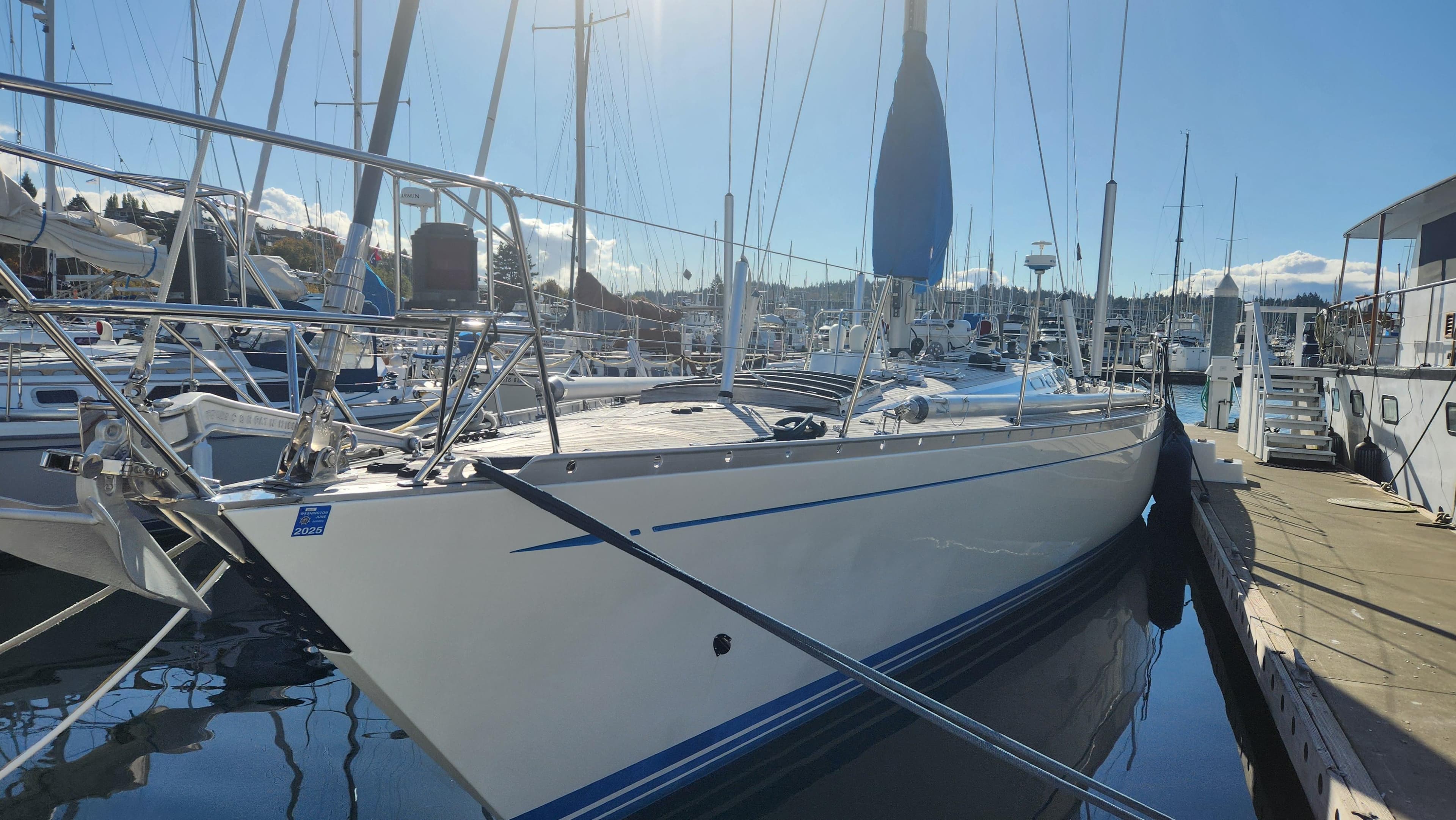 1983 Nautor Swan 651 yacht docked in a sunny marina.