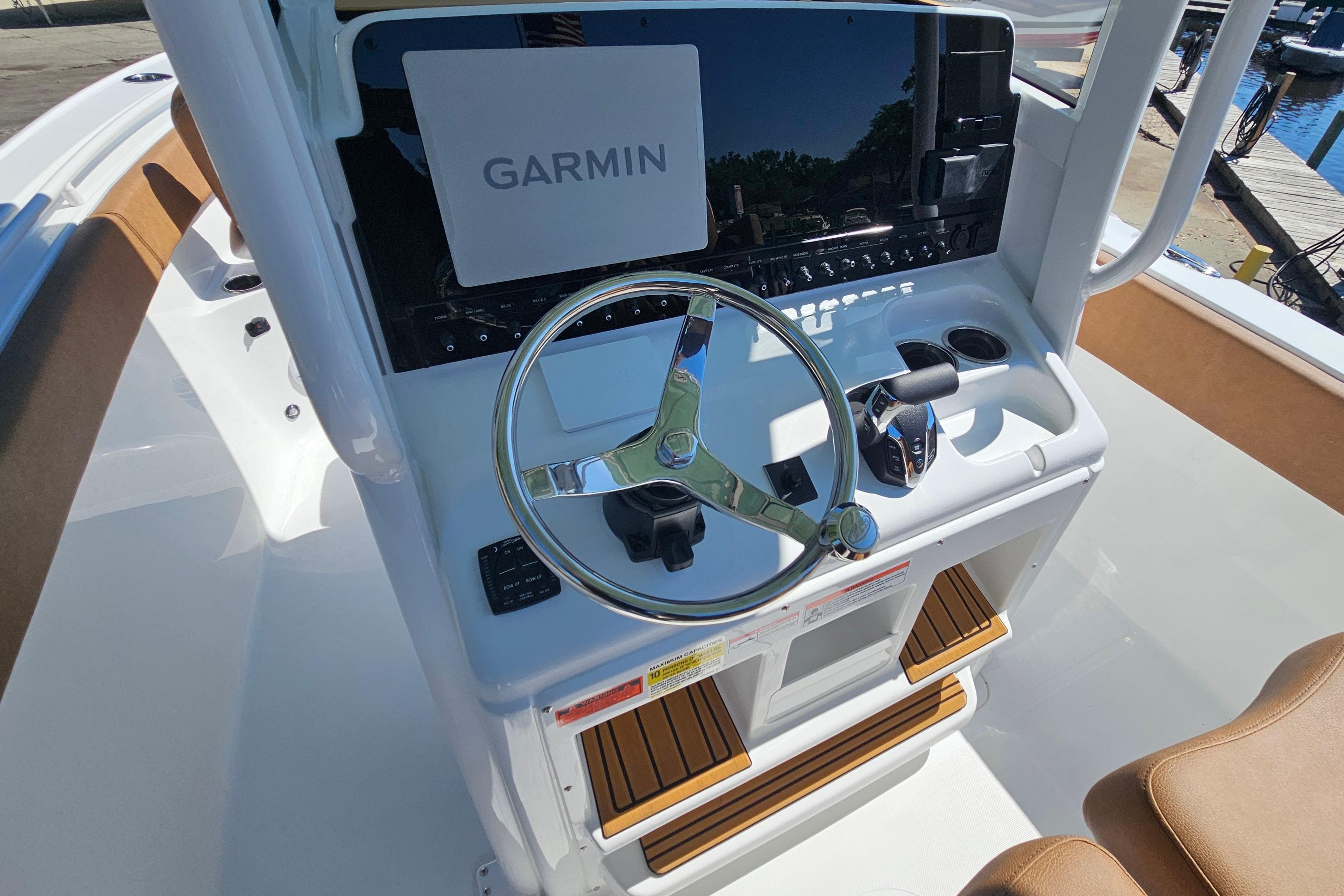 2026 Sea Hunt Ultra 255 SE boat dashboard with Garmin navigation system and steering wheel.