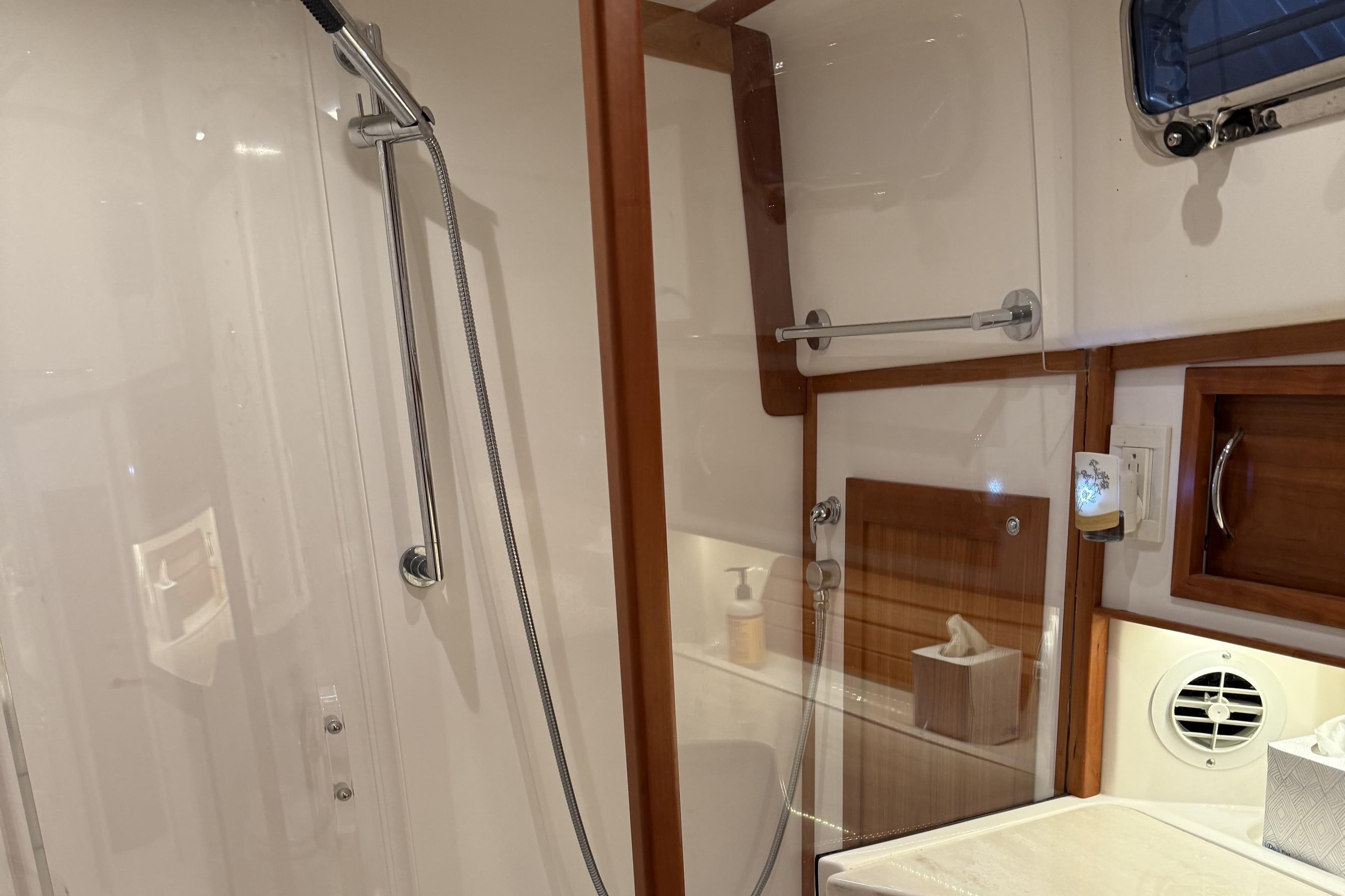 Luxurious bathroom interior of 2021 Sabre 42 Fly Bridge yacht with modern shower.