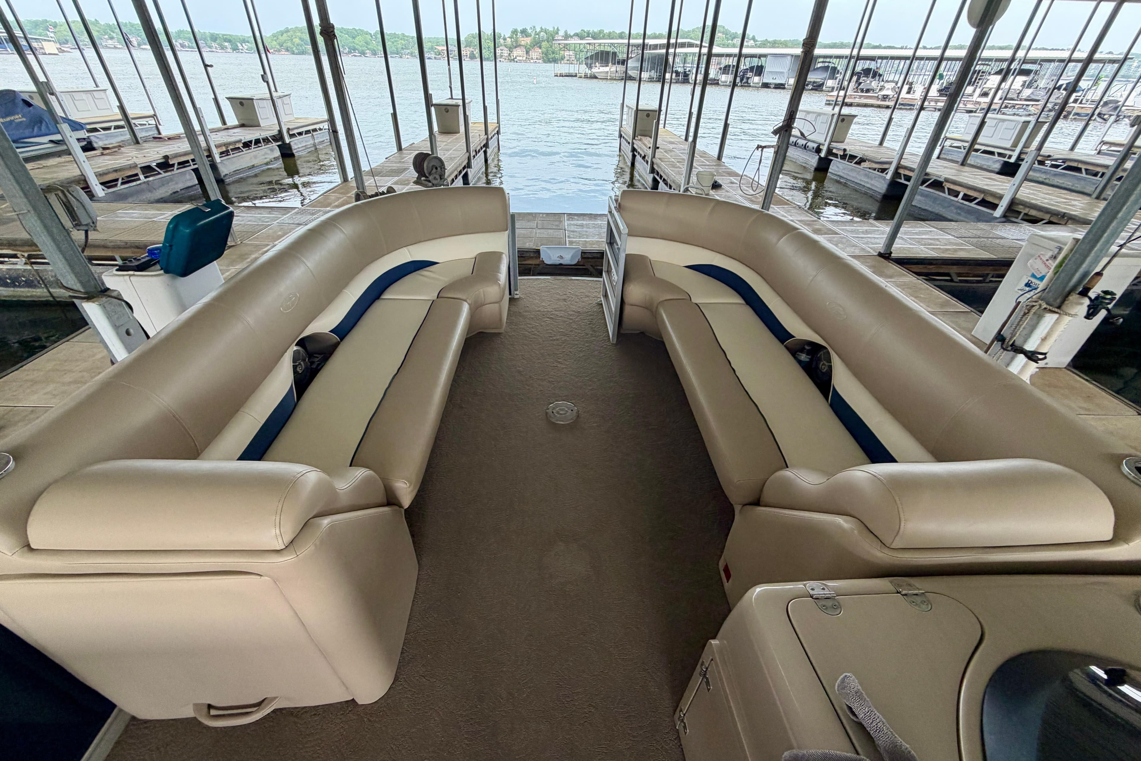 Interior of a 2013 Harris Solstice 240 pontoon boat with beige seating.