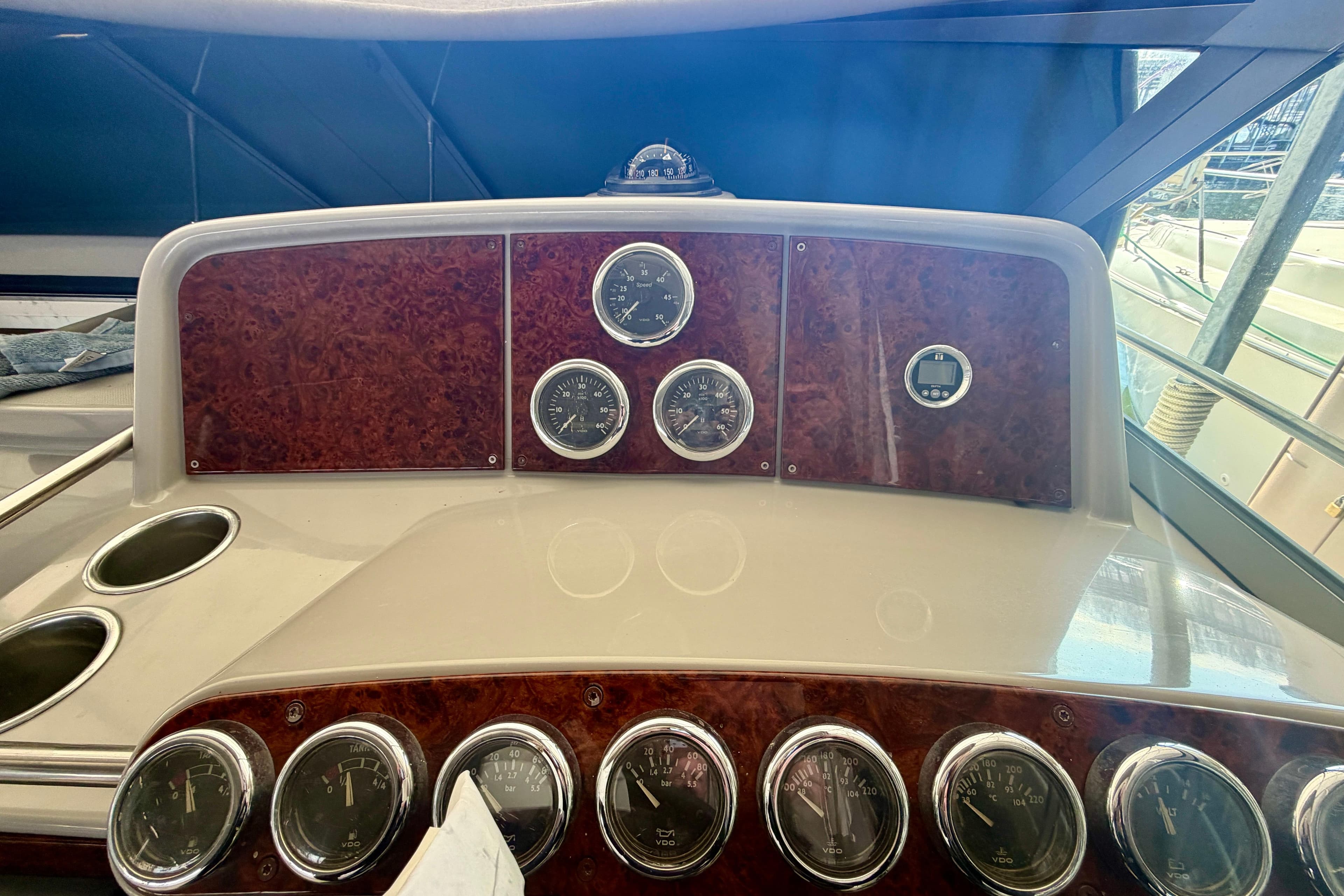 Dashboard of a 2002 Formula 37 Performance Cruiser with multiple gauges and wood paneling.