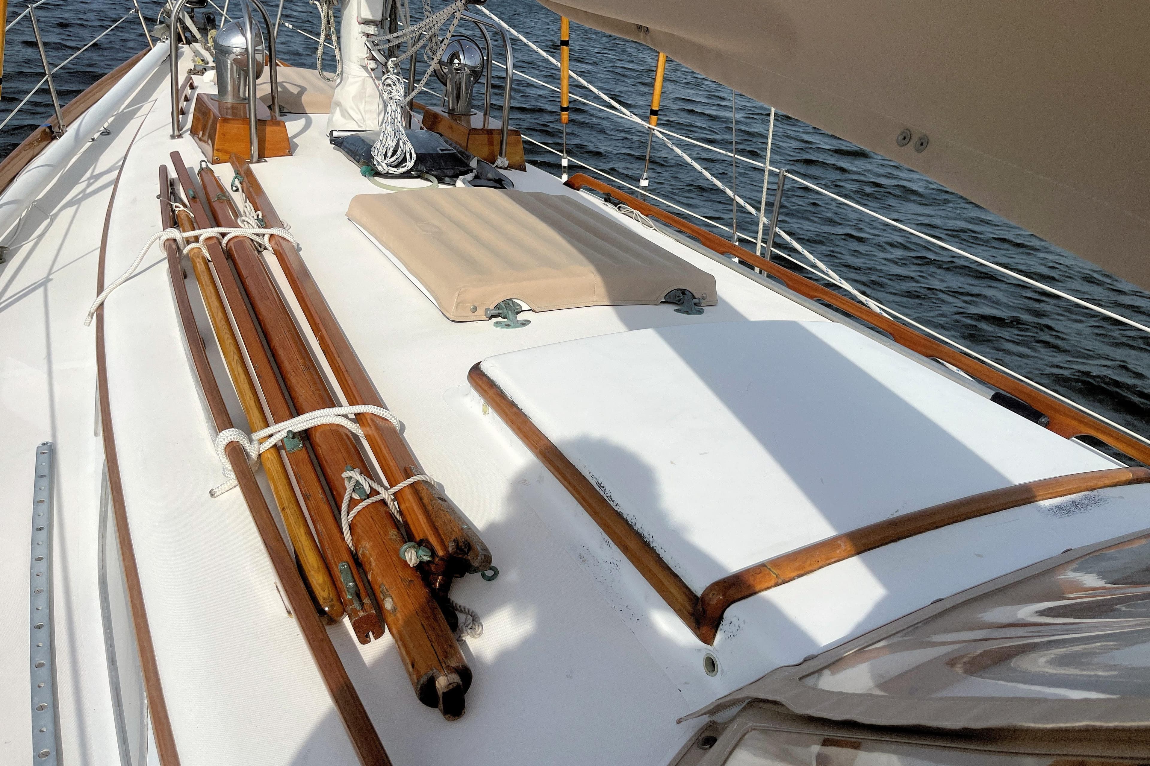 1981 Bristol 40 sailboat deck with wooden details and ropes, sailing on water.
