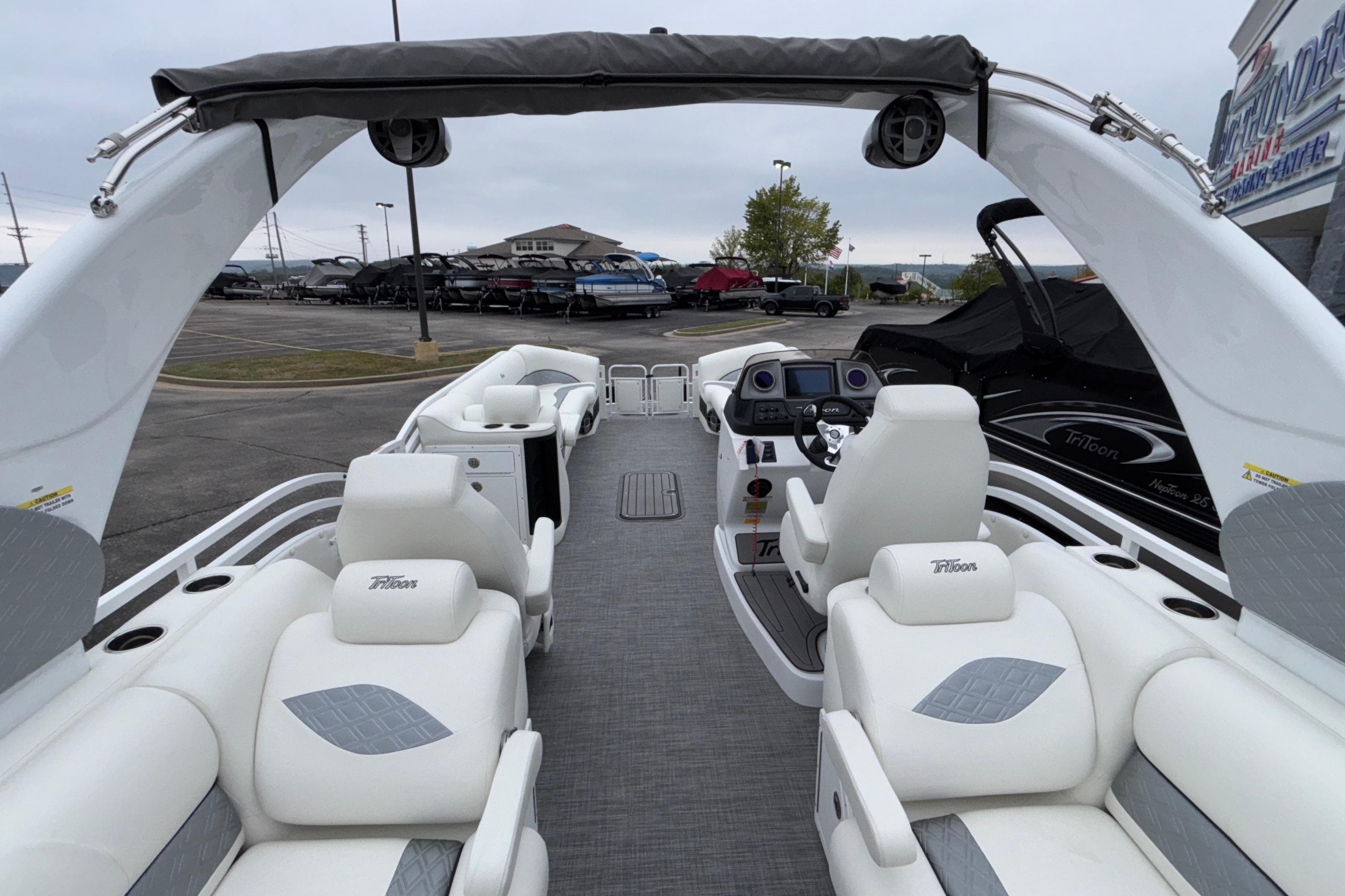 2026 JC NEPTOON 27TT SPORT boat interior with white seating and modern dashboard.