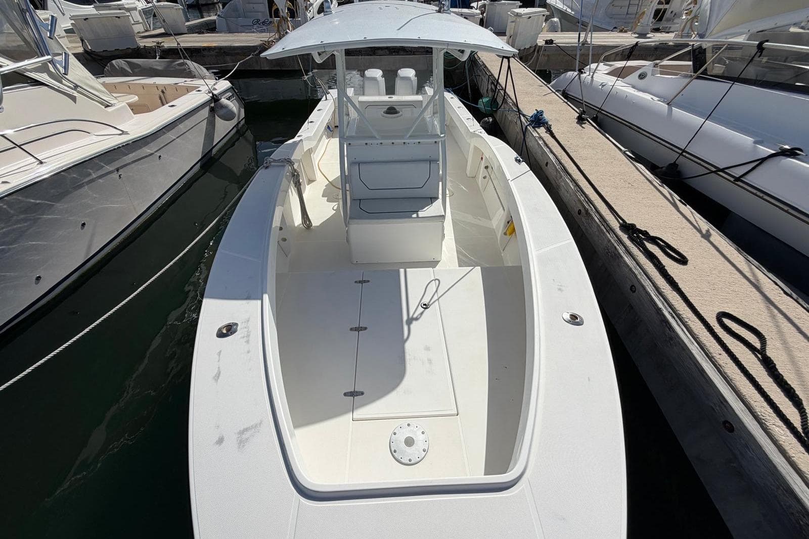 2002 Ocean Master 31 Center Console boat docked at marina, top view.