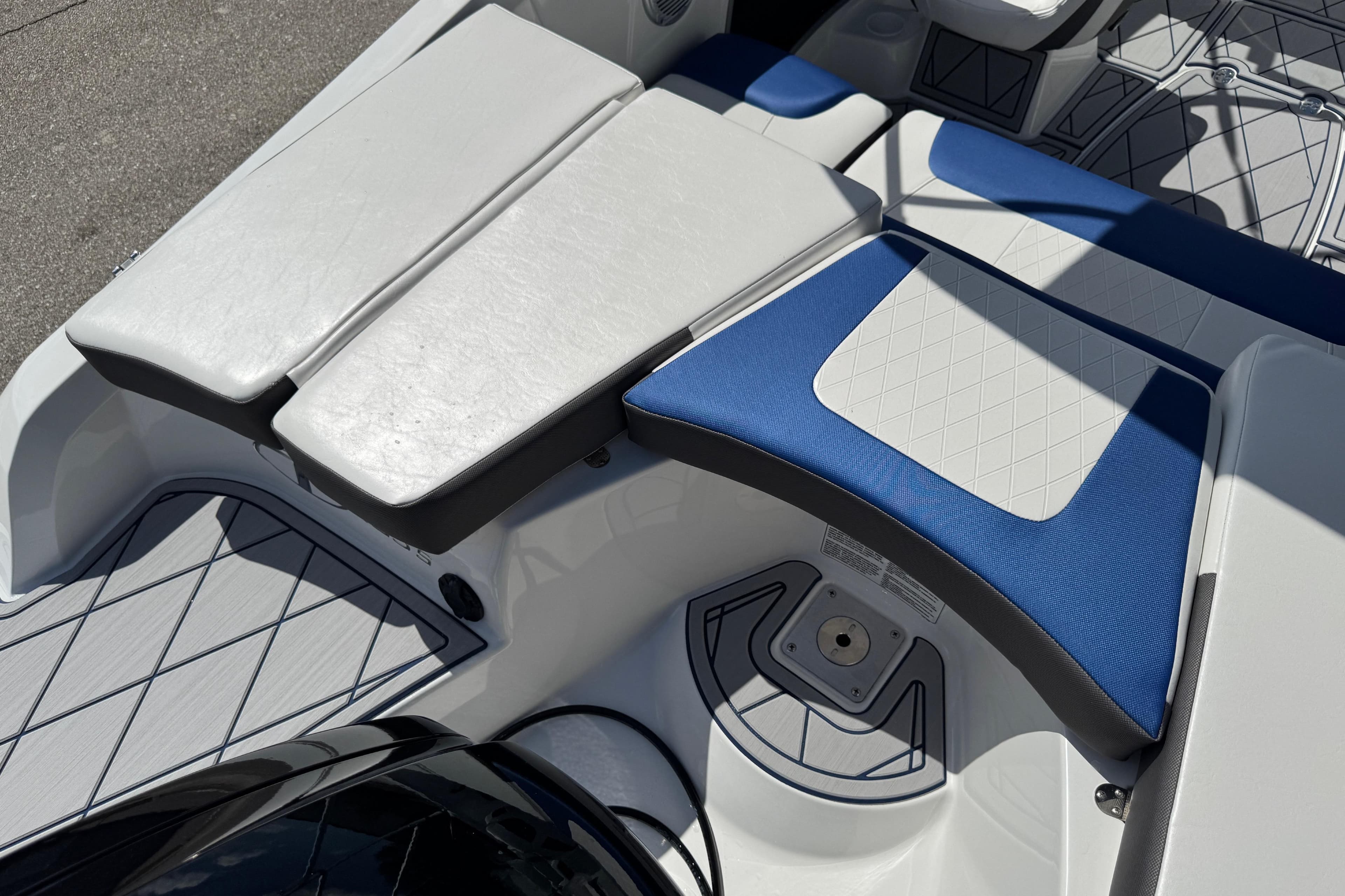 2024 Tahoe 185 S boat interior with white and blue cushioned seating.