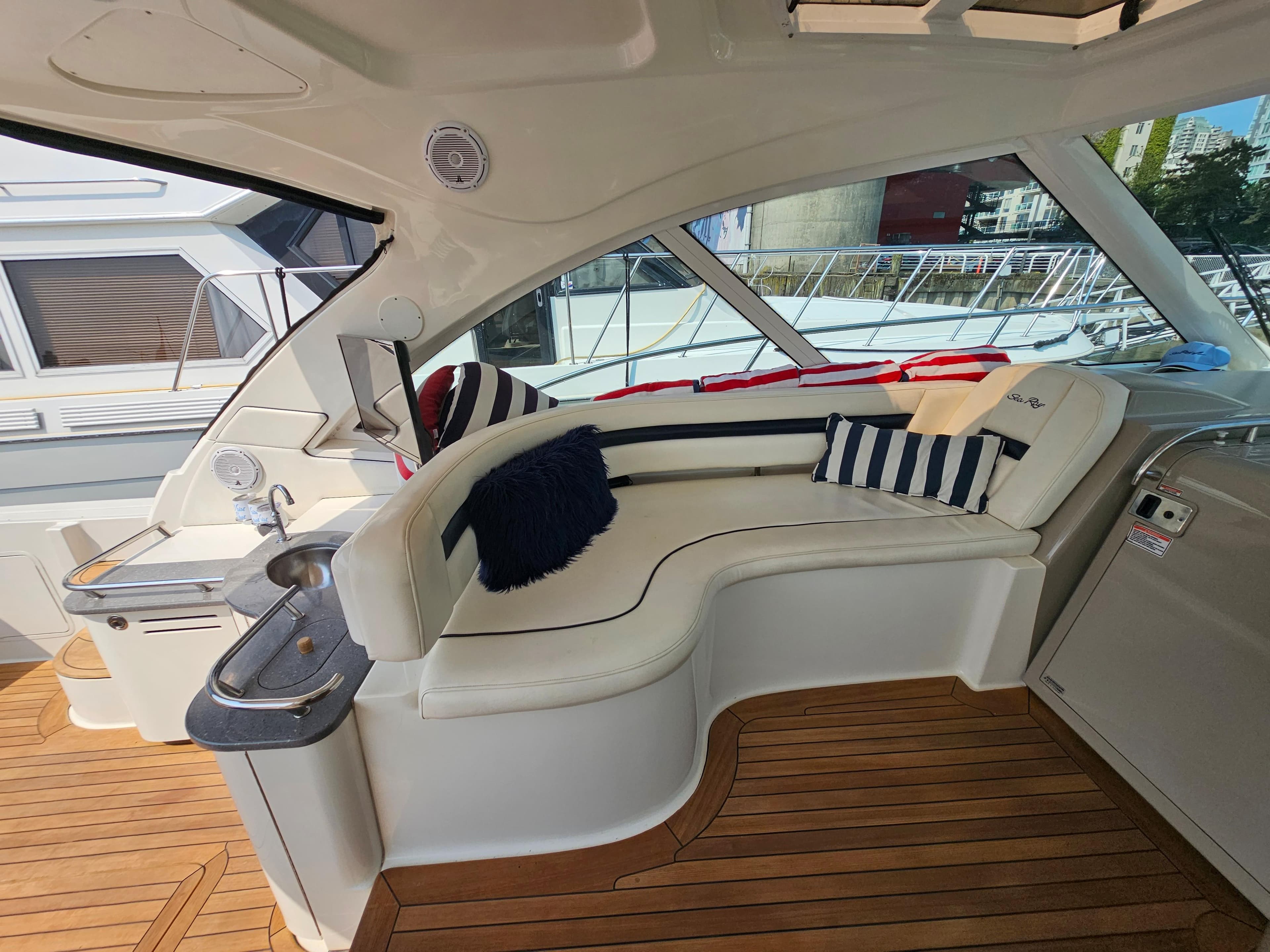 Luxurious 2005 Sea Ray 48 Sundancer yacht interior with plush seating and elegant wood flooring.