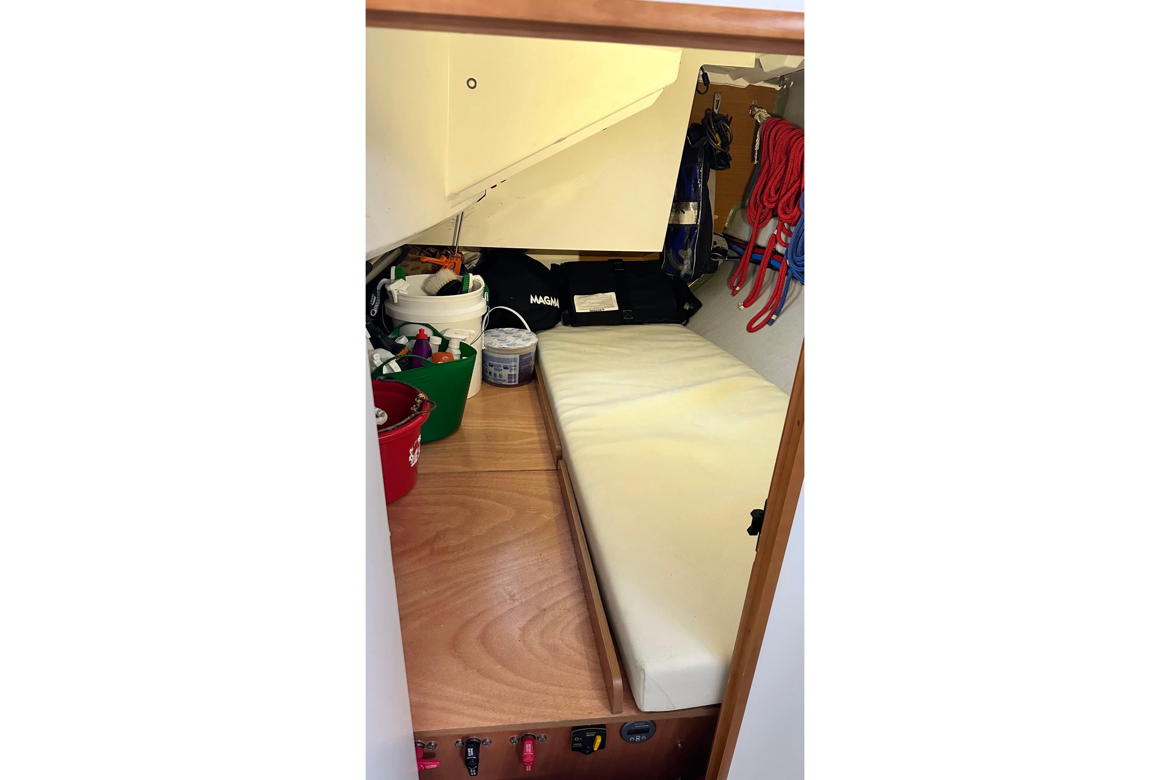 Interior storage area of 2016 Jeanneau Sun Odyssey 349 sailboat with organized equipment.