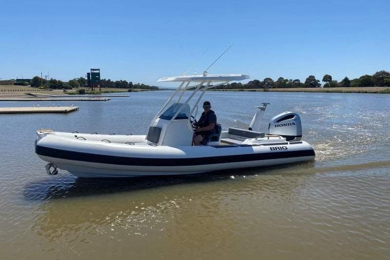 2026 Brig Eagle 6.7 boat with Honda engine cruising on a calm river.