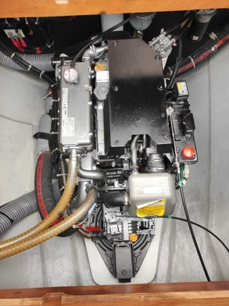 Engine compartment of a 2017 Lagoon 450S catamaran, showcasing mechanical components and hoses.
