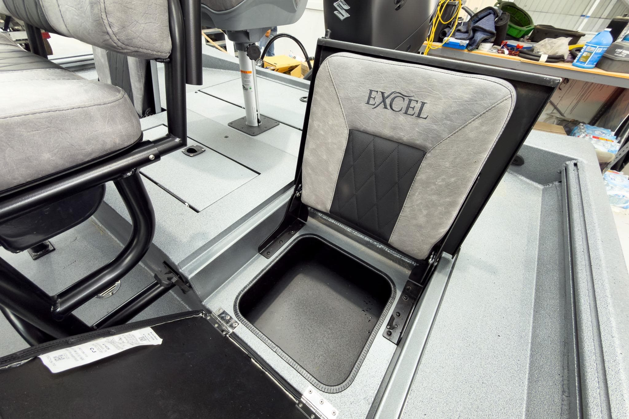 2026 Excel 230 Bay Pro Elite boat seat with storage compartment open.