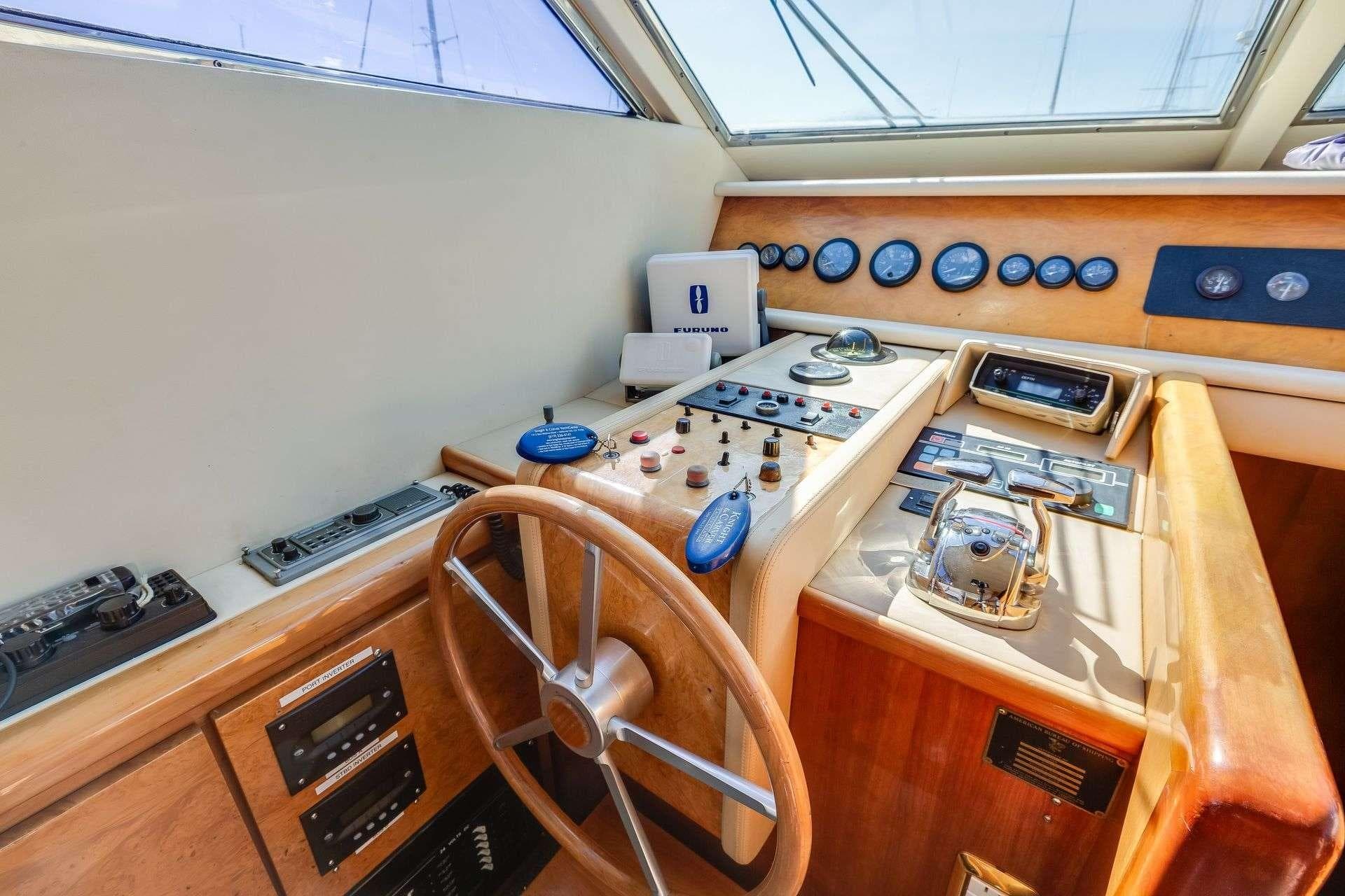 1988 Azimut Motor Yacht helm with wooden steering wheel and control panel.