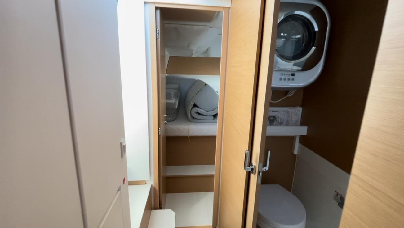 Compact bathroom in 2021 Excess 11 yacht with modern amenities and storage.