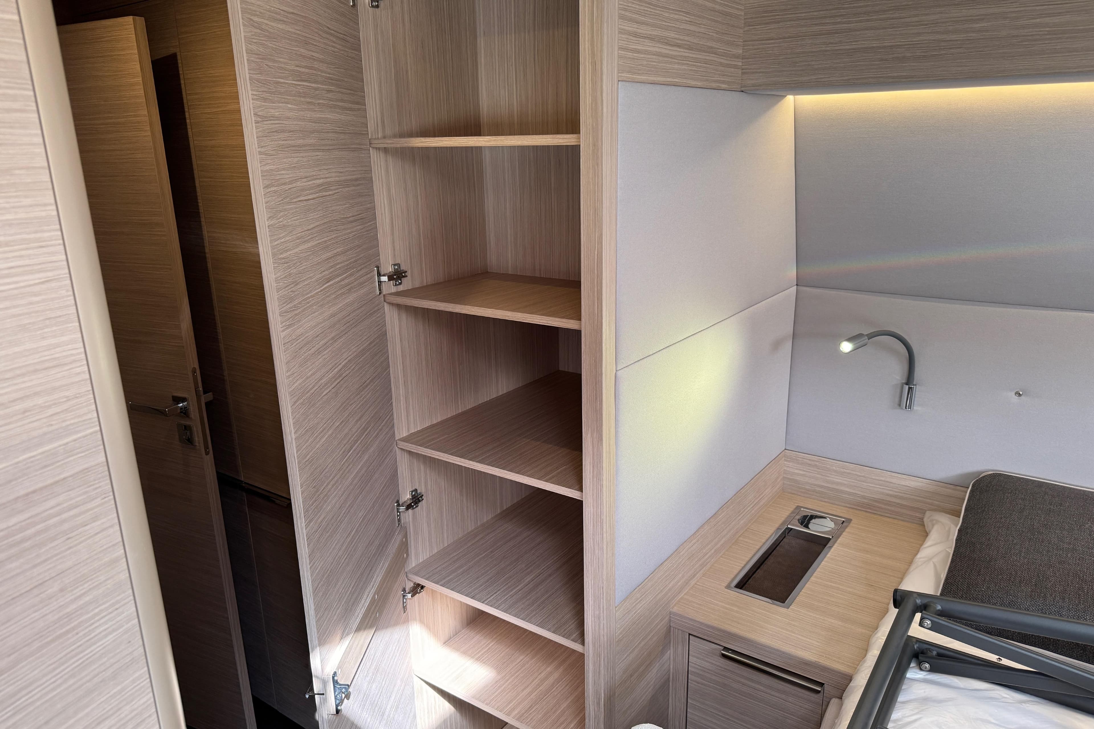 Interior of 2026 Lagoon 55 yacht with open shelving and modern lighting.