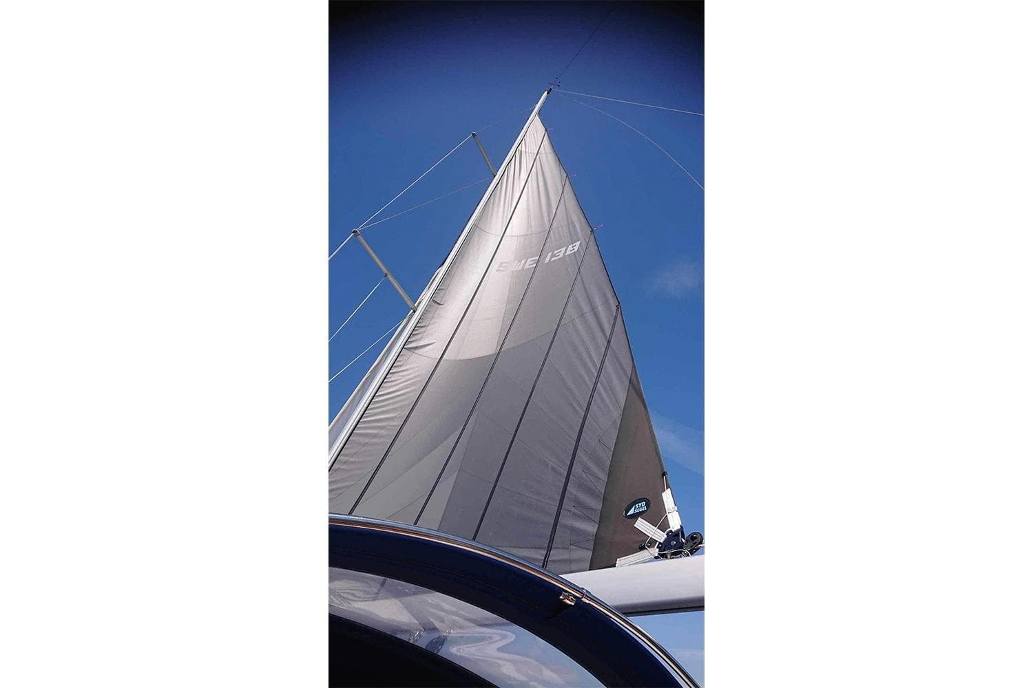 Sail of a 2007 Dufour 455 GL yacht against a clear blue sky.
