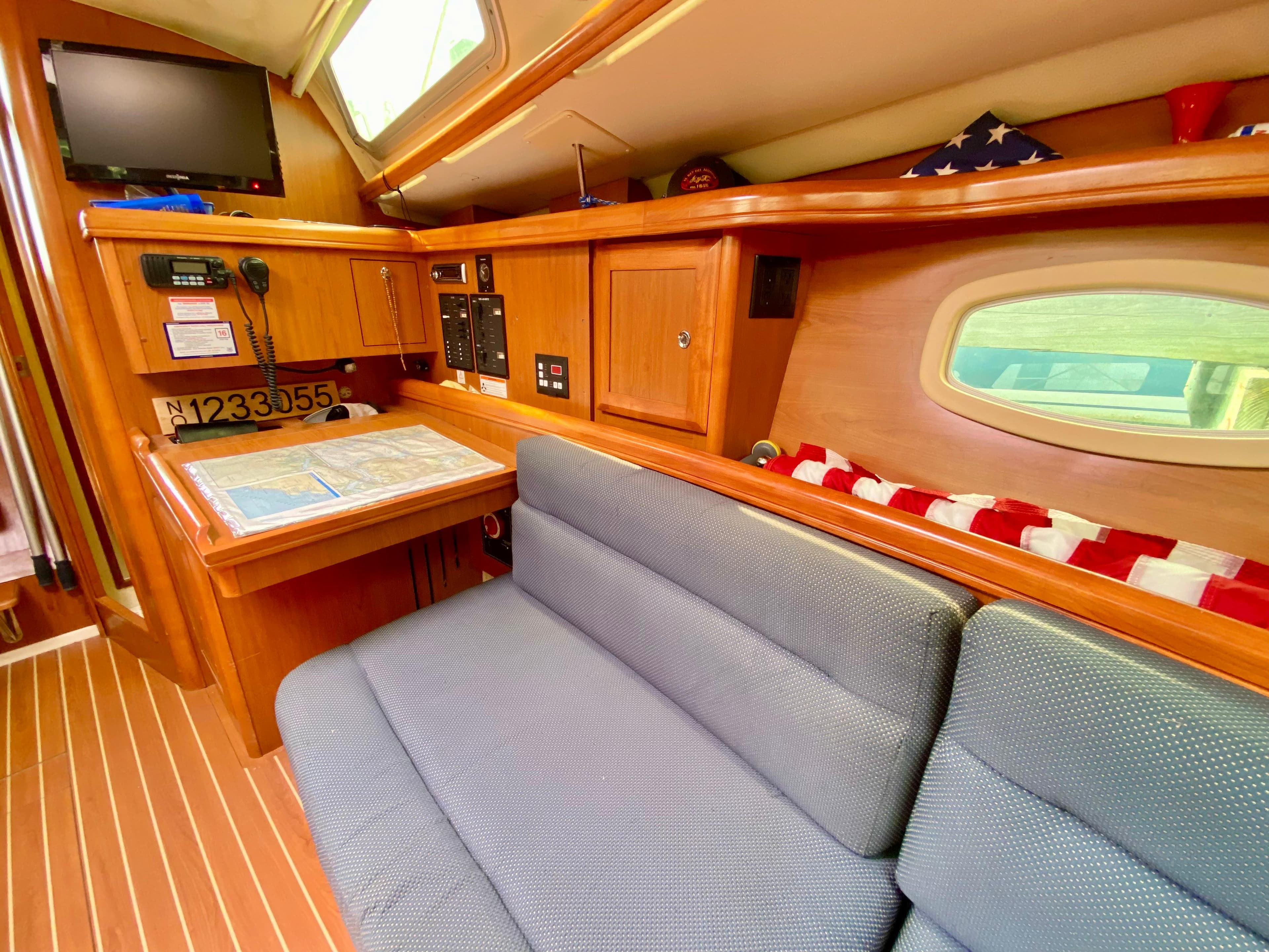 Interior of 2008 Hunter 36-2 sailboat with cozy seating and navigation area.