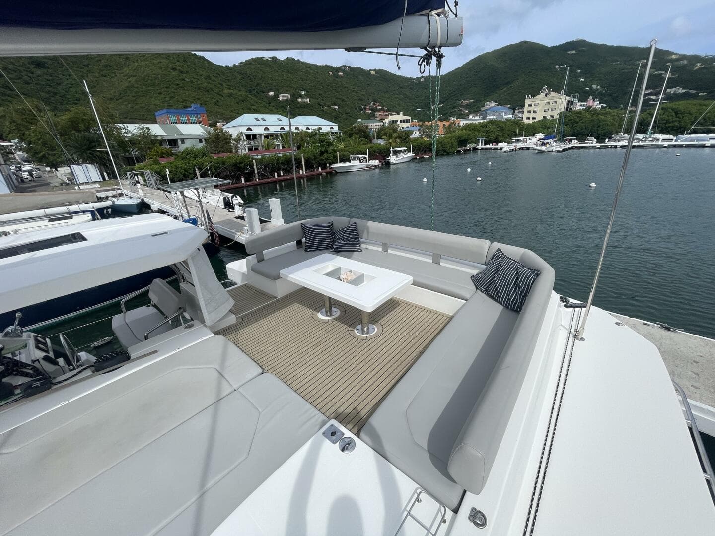 Luxurious 2019 Leopard 50 yacht with spacious deck, docked in scenic marina.