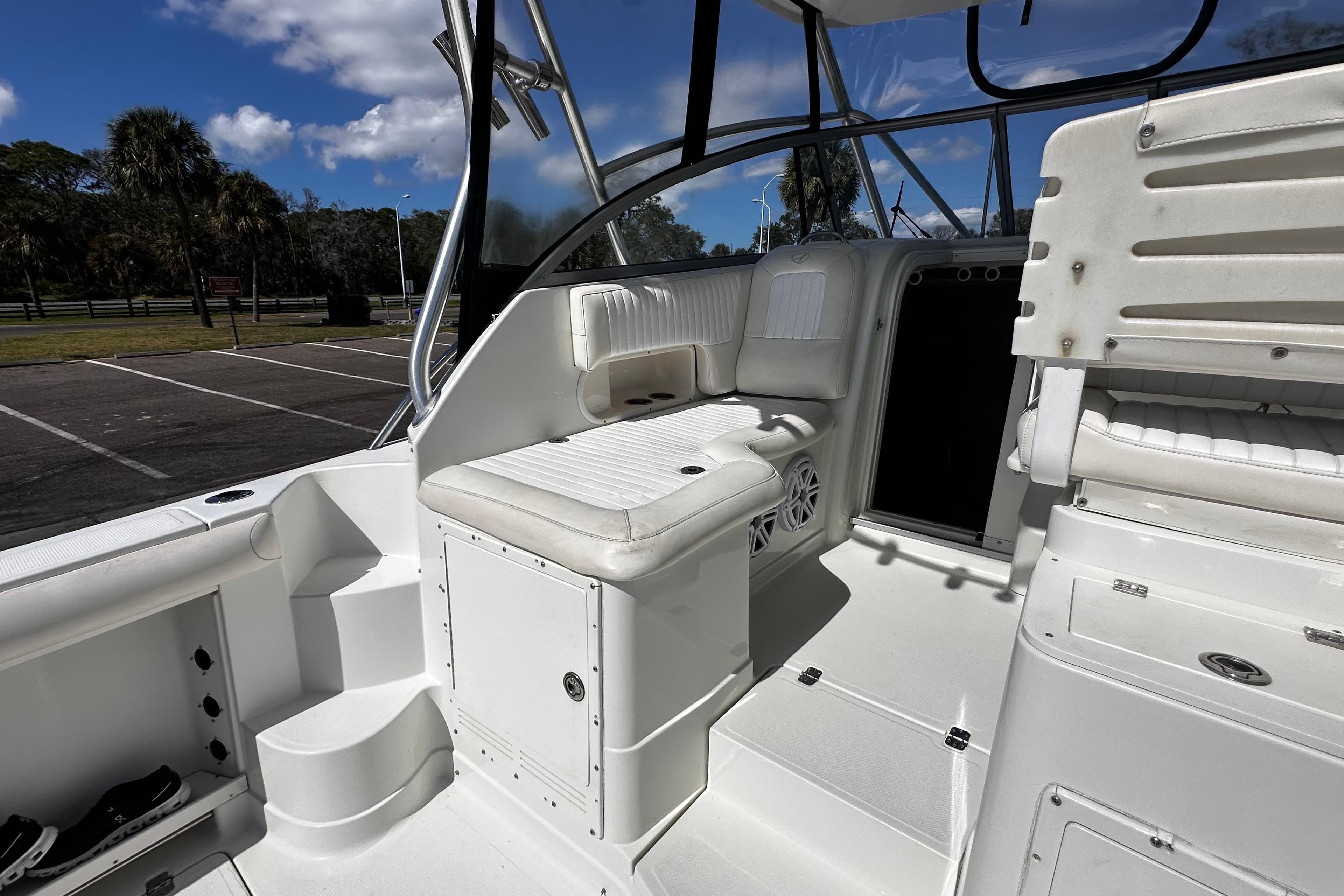 2008 Sailfish 3006 boat interior with white seating and storage compartments.