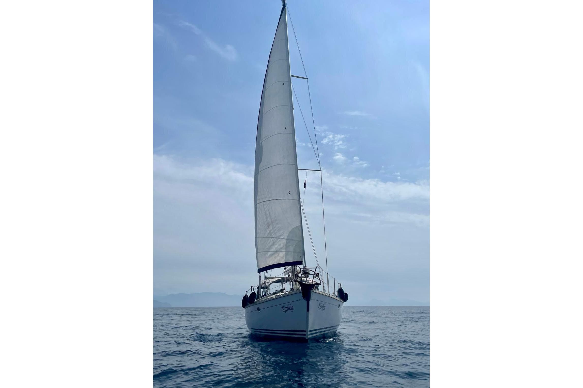 Sailing yacht Jeanneau Sun Odyssey 45.1, 1995 model, on open sea under clear sky.