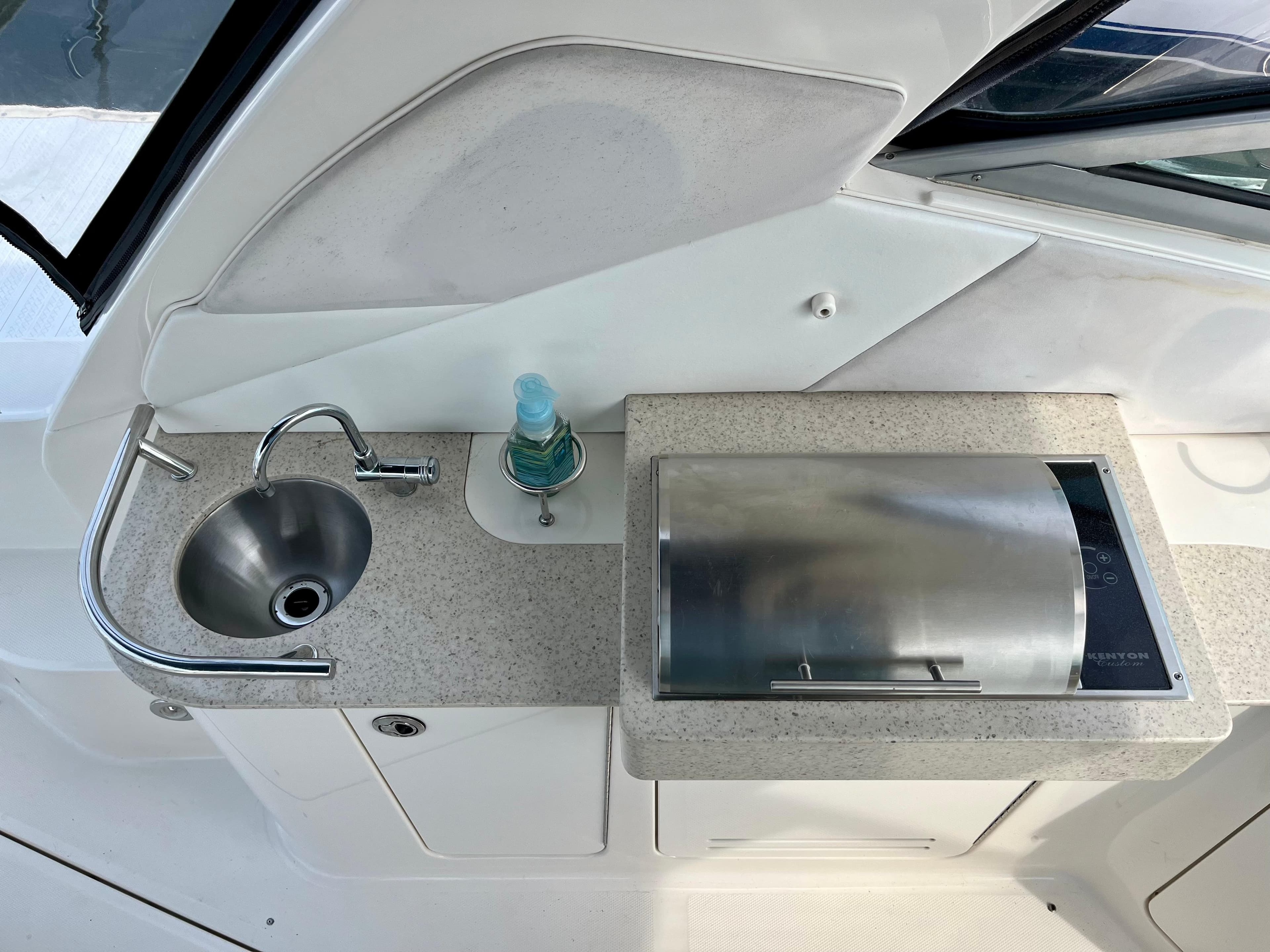 2009 Sea Ray 310 Sundancer boat kitchenette with sink and grill.