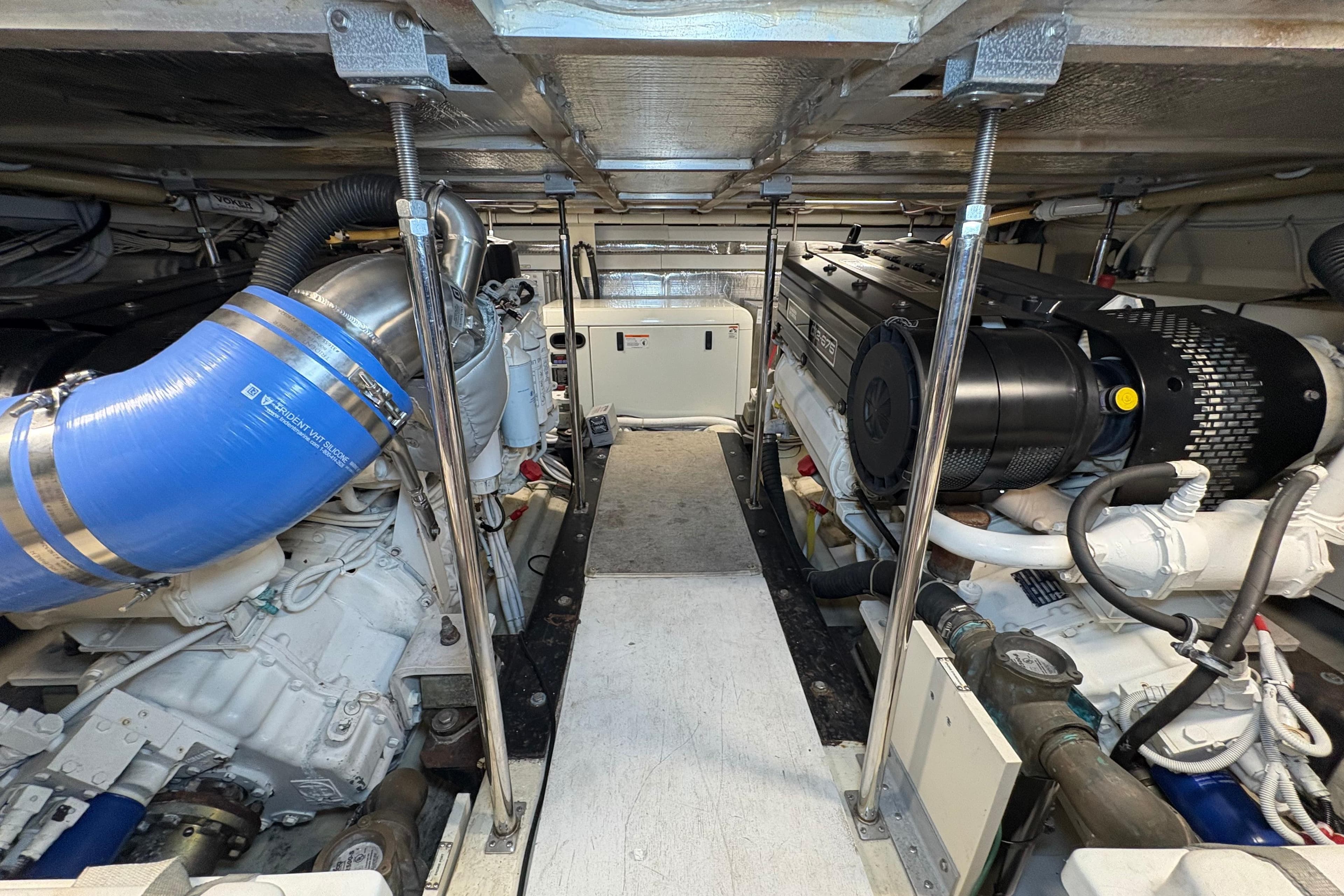 Engine room of a 2004 Carver 560 Voyager yacht, showcasing dual engines and mechanical components.