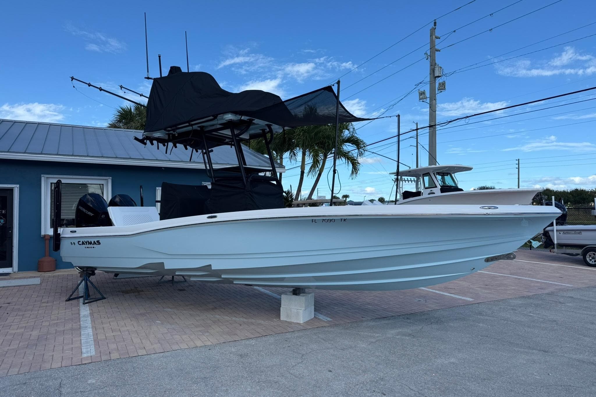 2023 Caymas 28 HB Twin boat displayed outdoors on a stand.