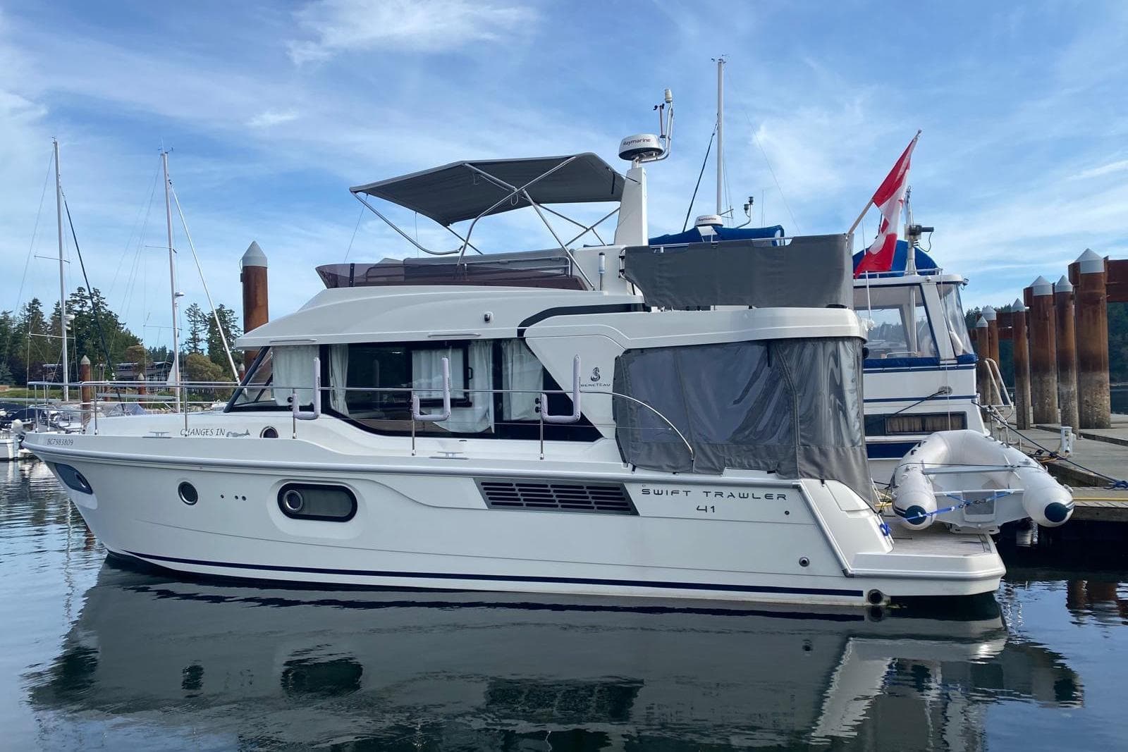 2022 Beneteau Swift Trawler 41 Fly docked at marina, side view.